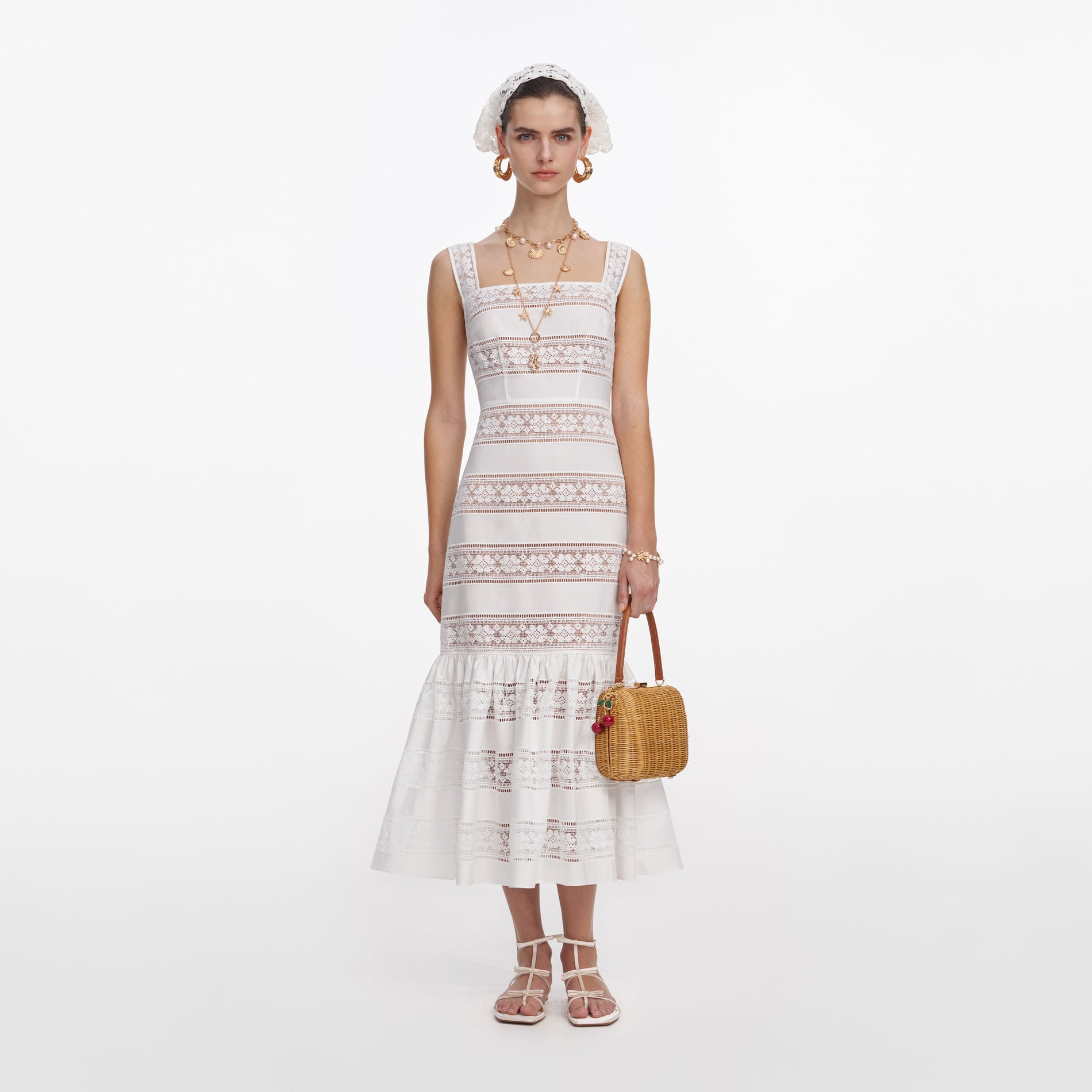 Front view of a woman wearing the White Cotton Embroidered Midi Dress