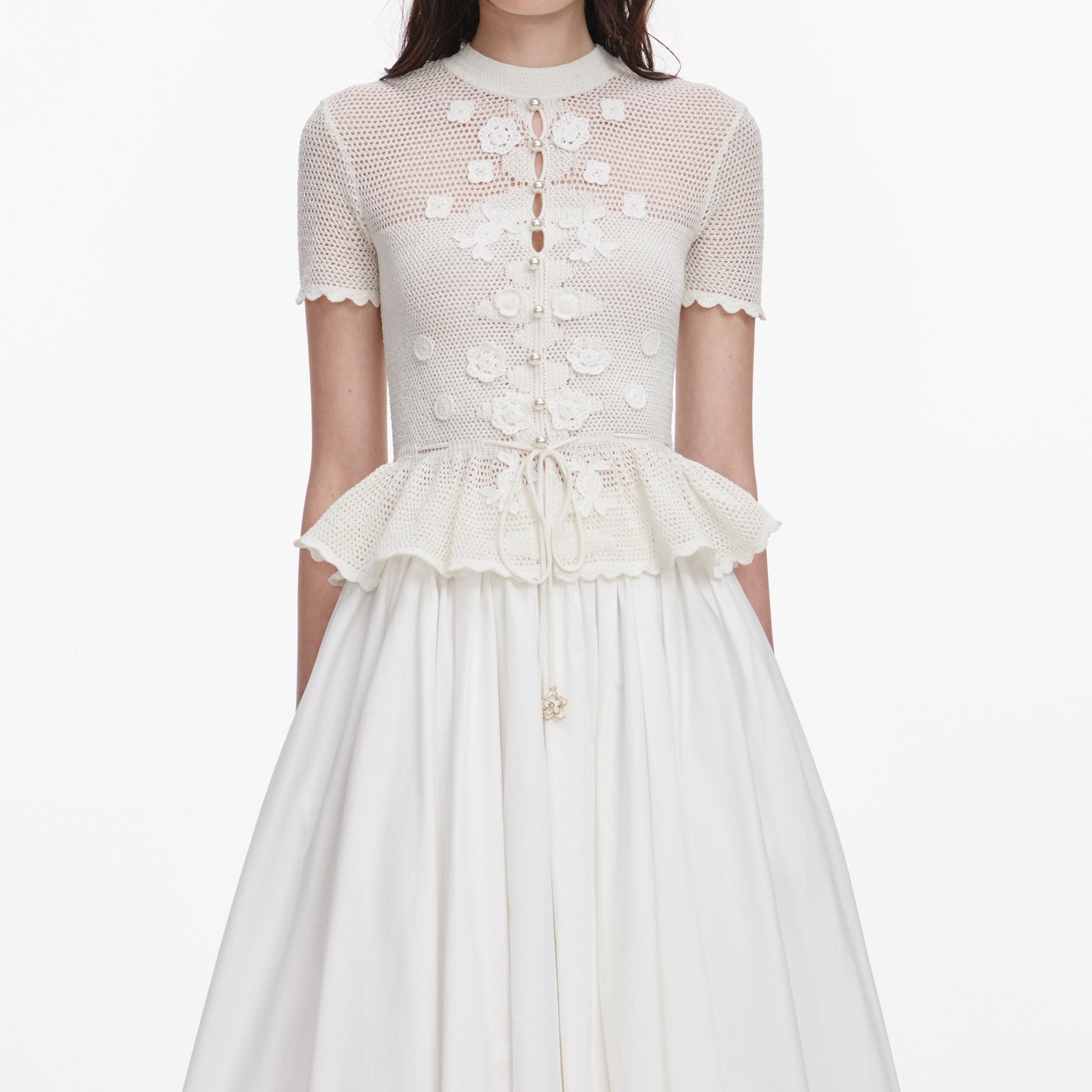 A close up of a woman wearing the White Floral Crochet Top