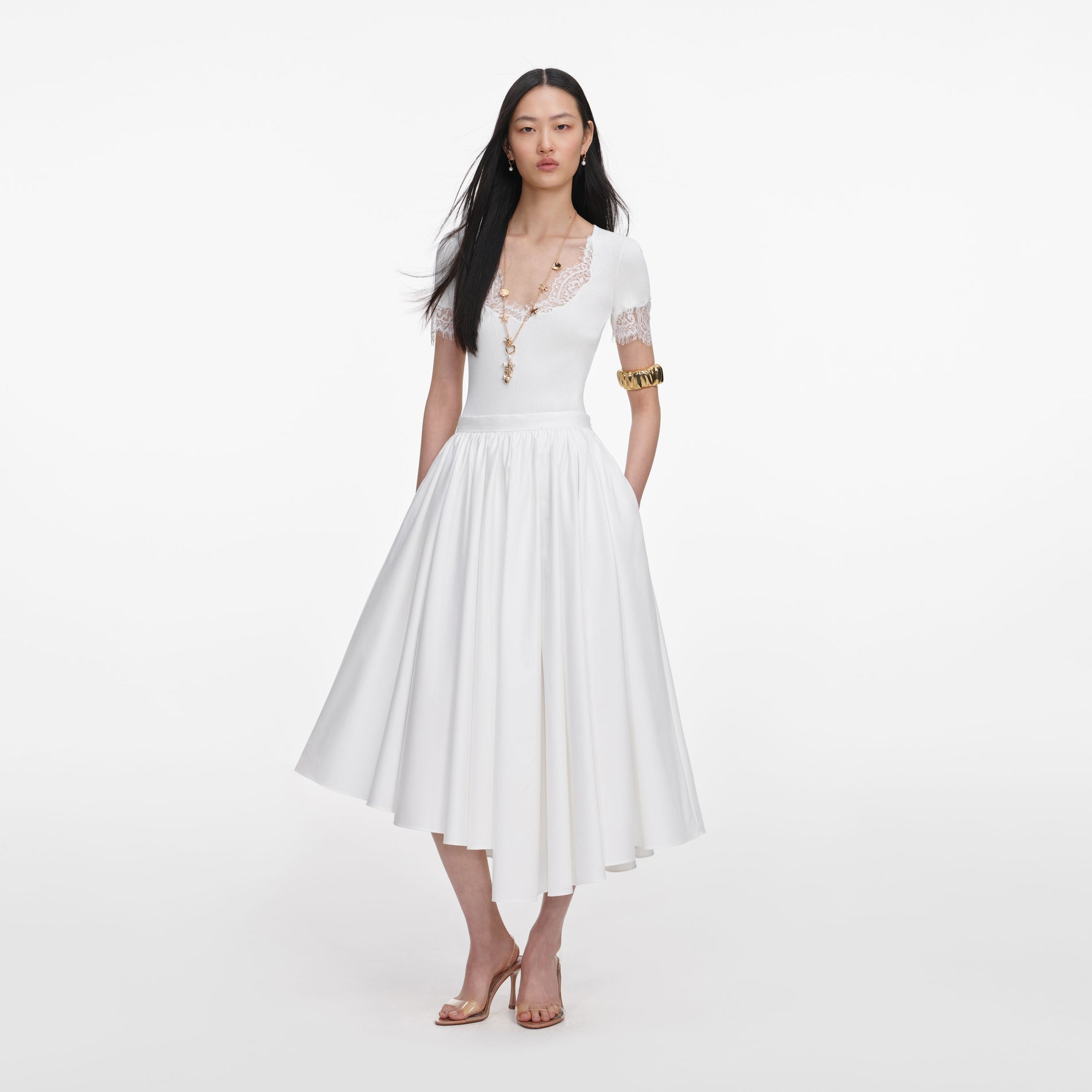 Front view of a woman wearing the White Cotton Poplin Midi Skirt