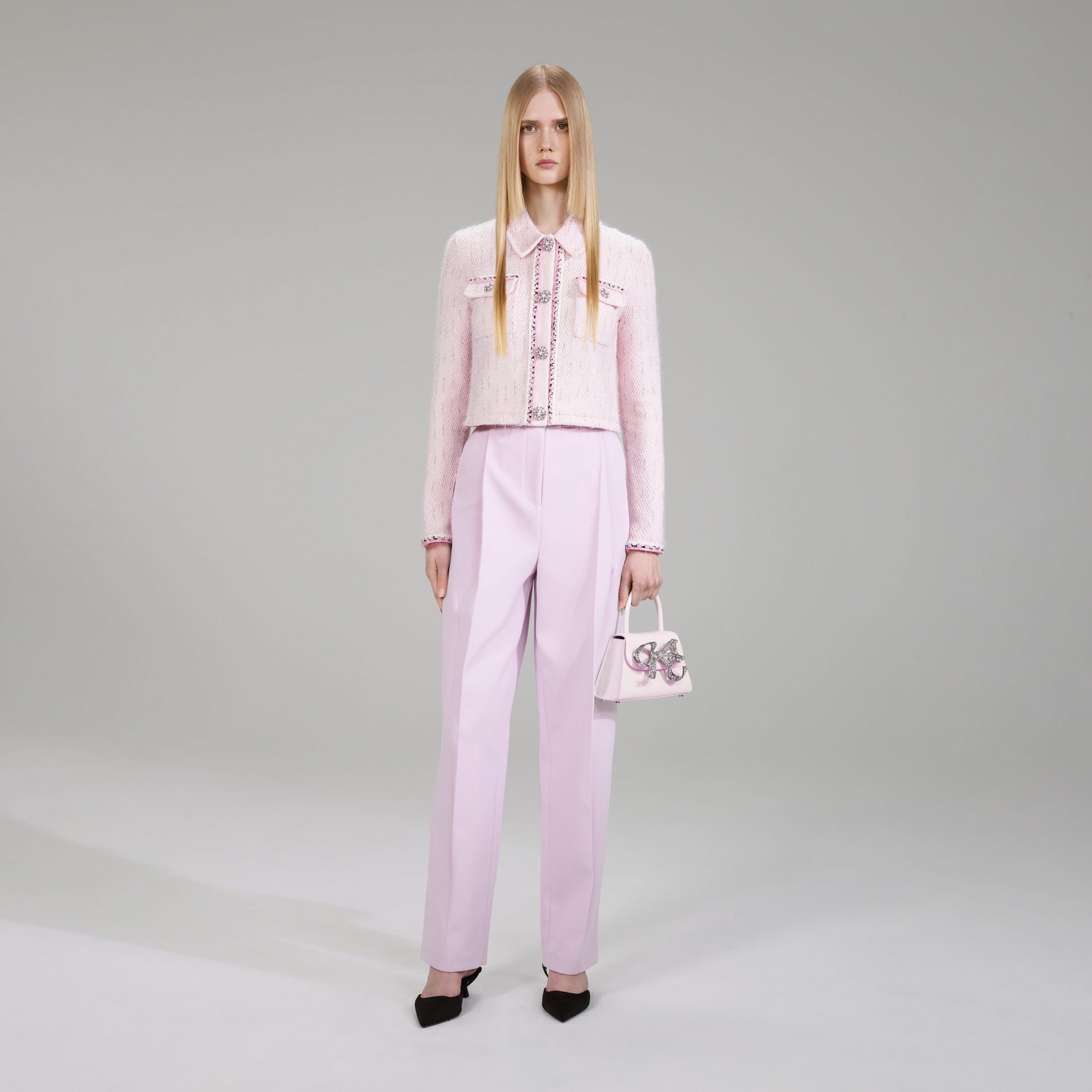 A woman wearing the Pink Melange Knit Cardigan