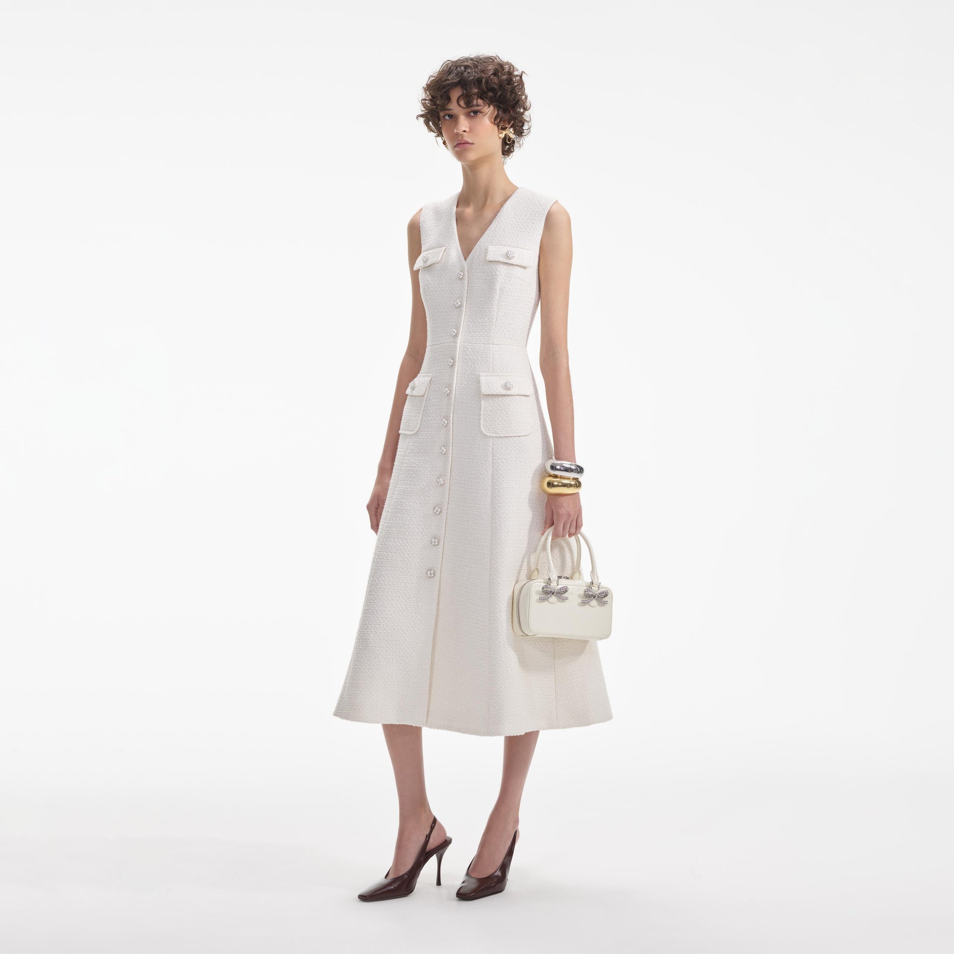 Side view of a woman wearing the Cream Tinsel Boucle Buttoned Midi Dress