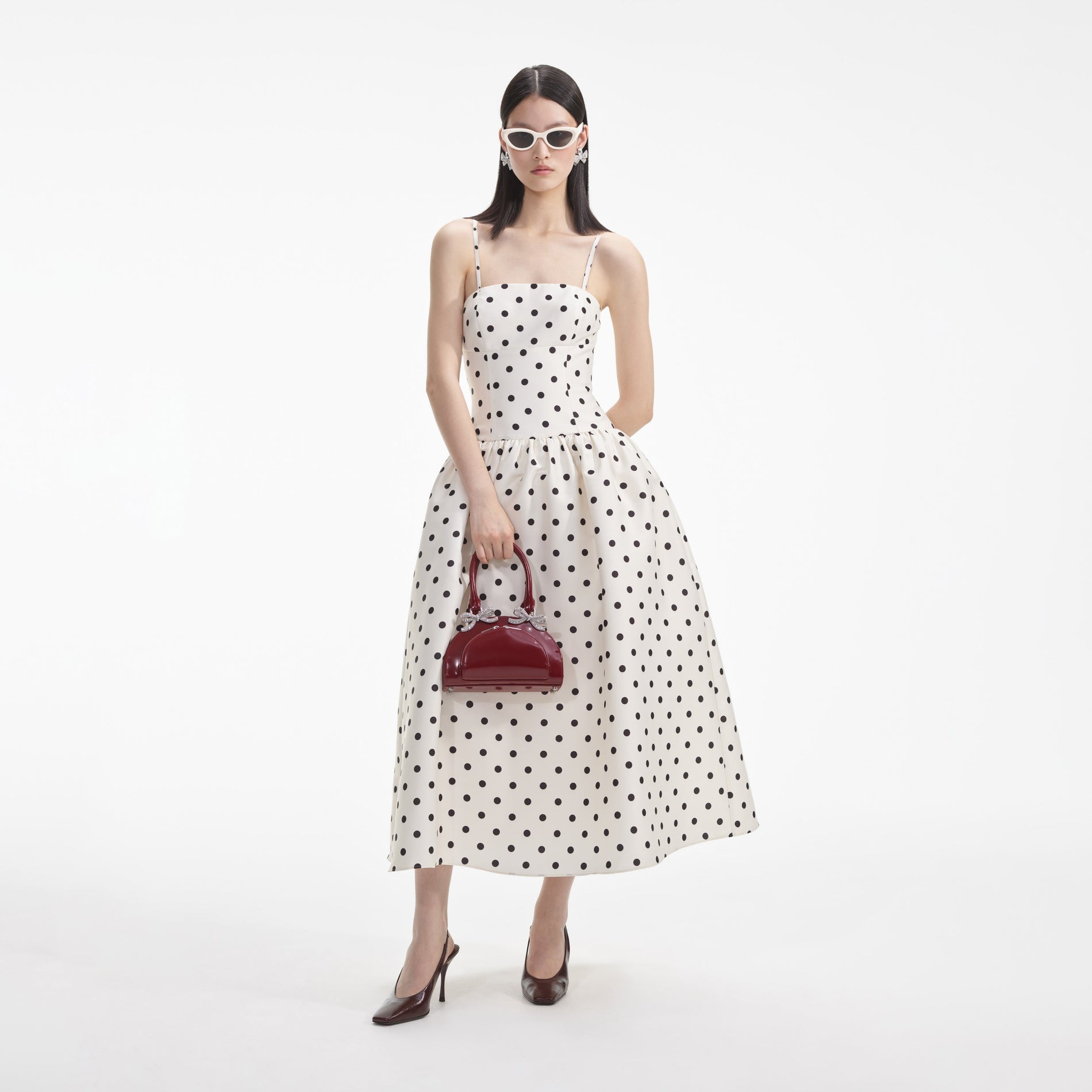 Side view of a woman wearing the Cream Polka Dot Taffeta Midi Dress