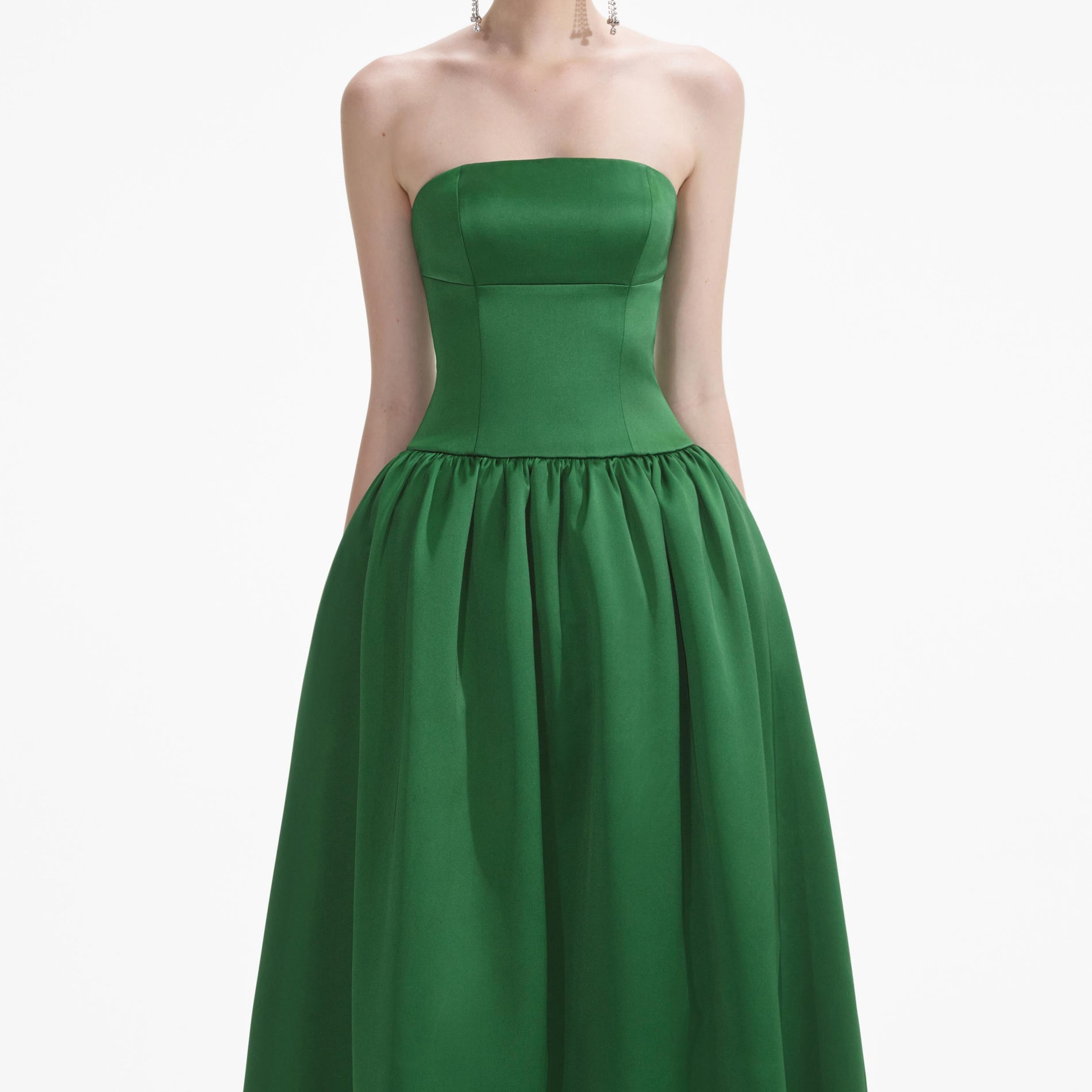 A close up of a woman wearing the Green Satin Bandeau Maxi Dress
