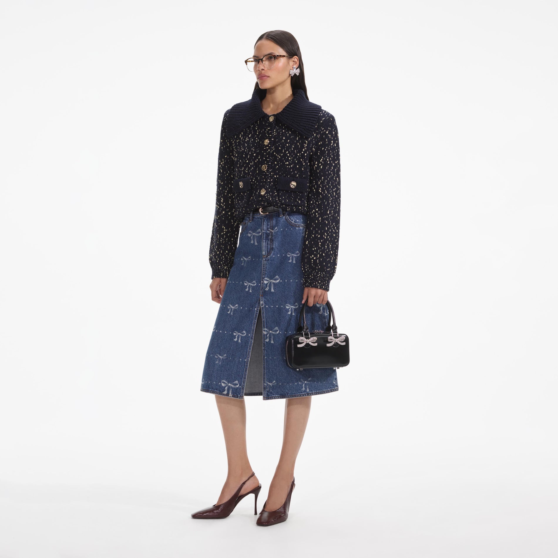 Side view of a woman wearing the Navy Metallic Merino Cardigan