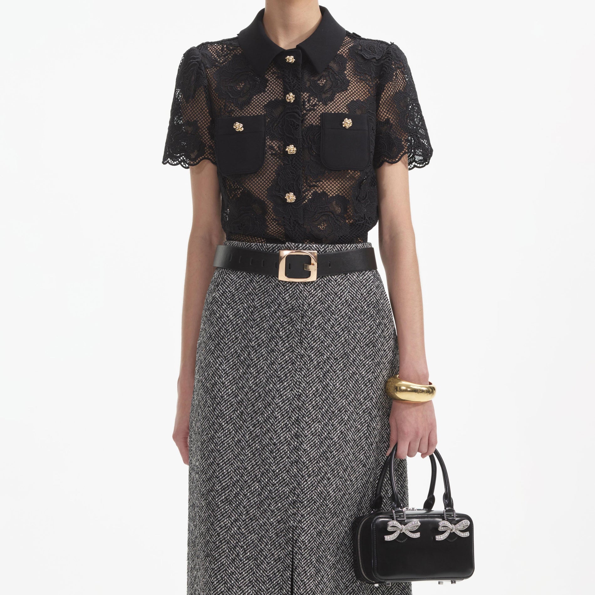 A close up of a woman wearing the Black Lace Top