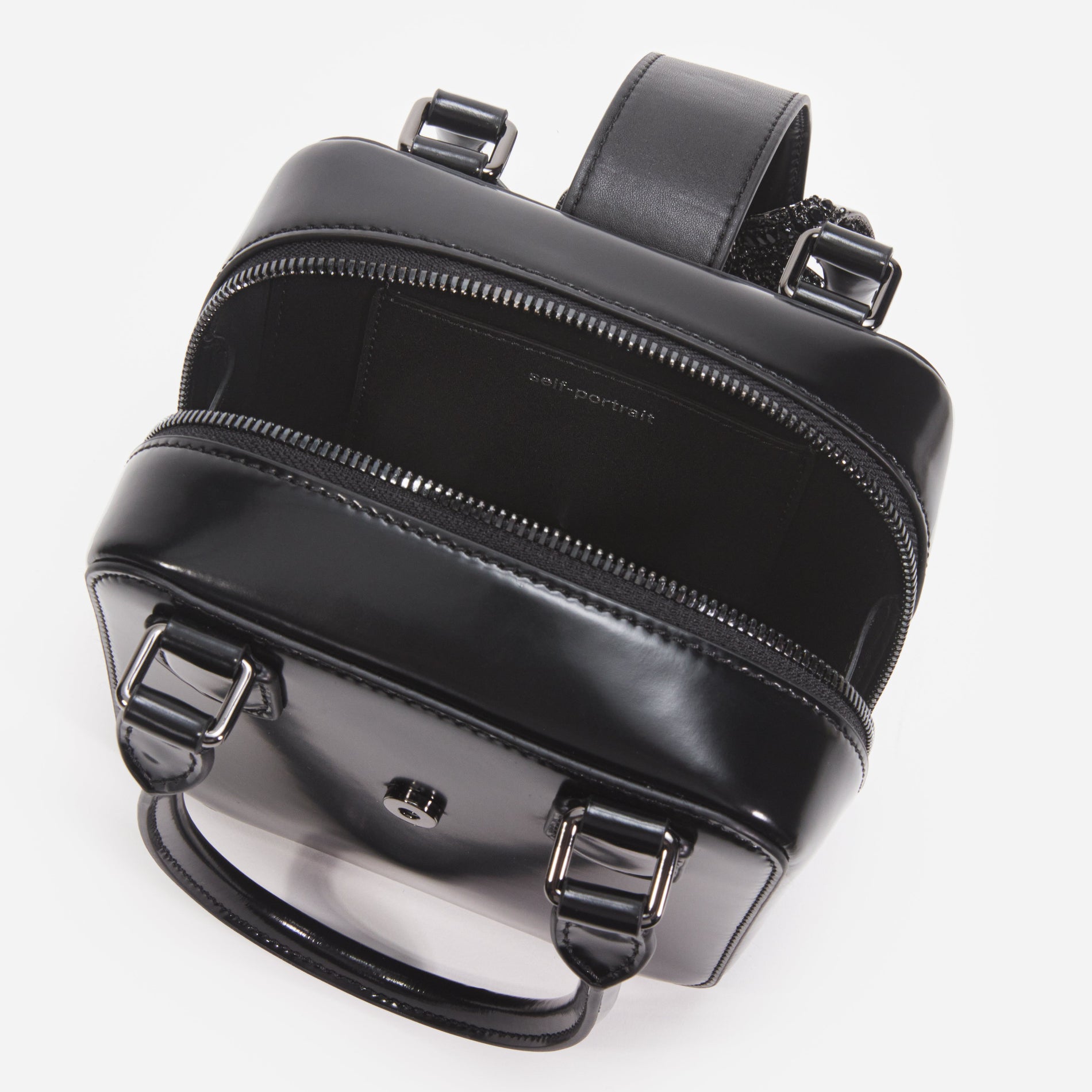 A close up of a woman wearing the Black Leather Square Mini Tote Bag