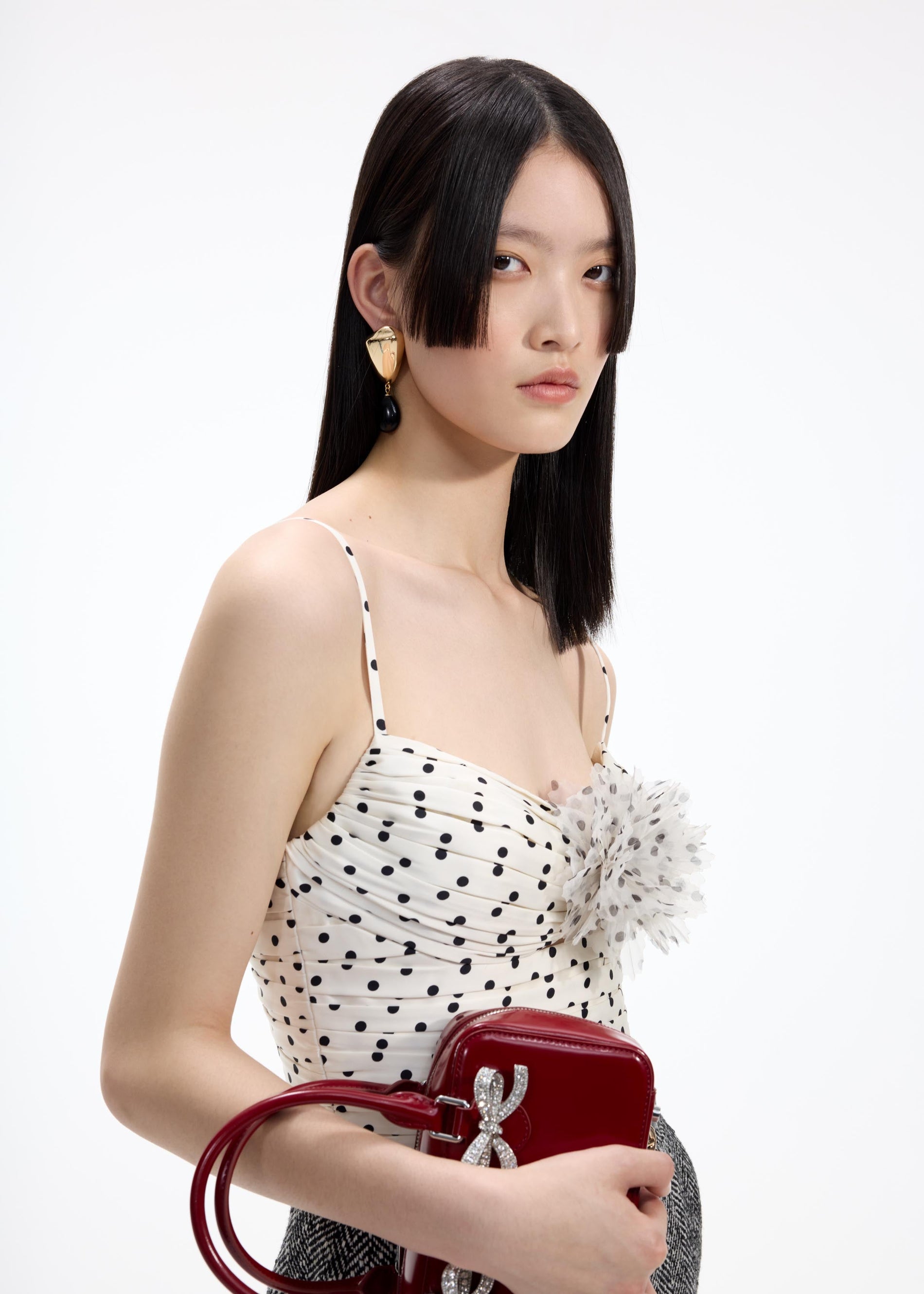 A close up of a woman wearing the Gold Droplet Earrings