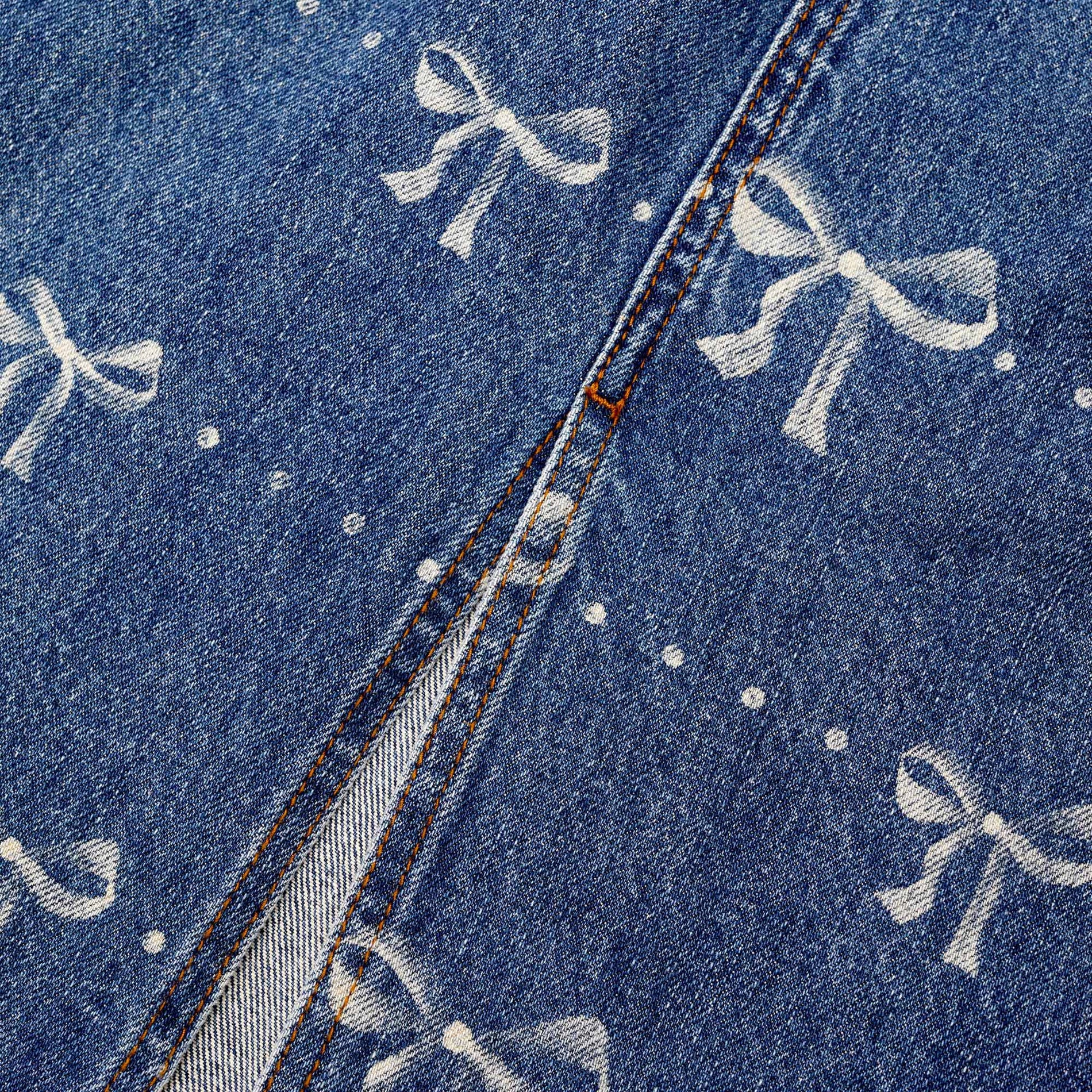 A close up of the fabric for the Bow Print Denim Midi Skirt