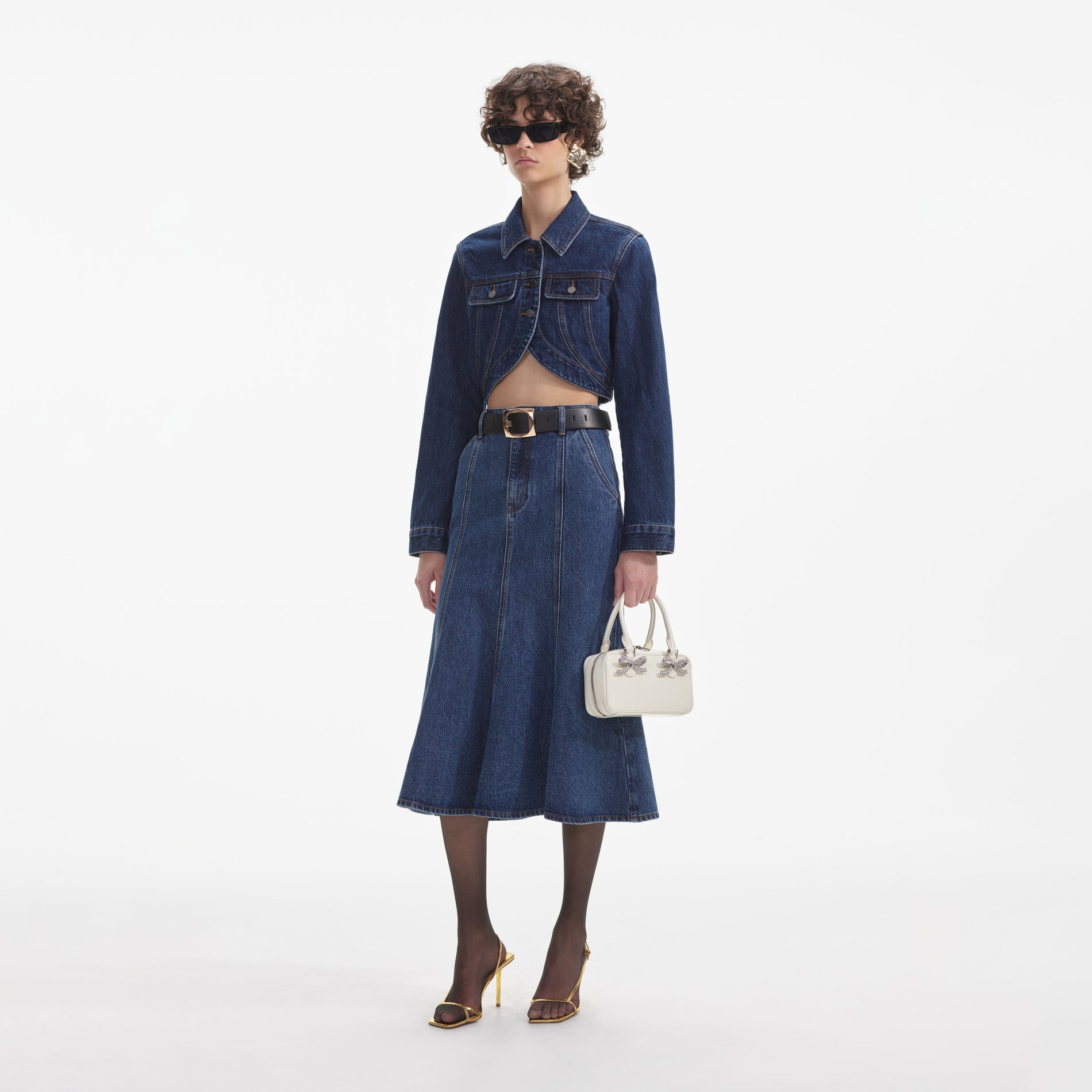 Side view of a woman wearing the Cropped Denim Jacket