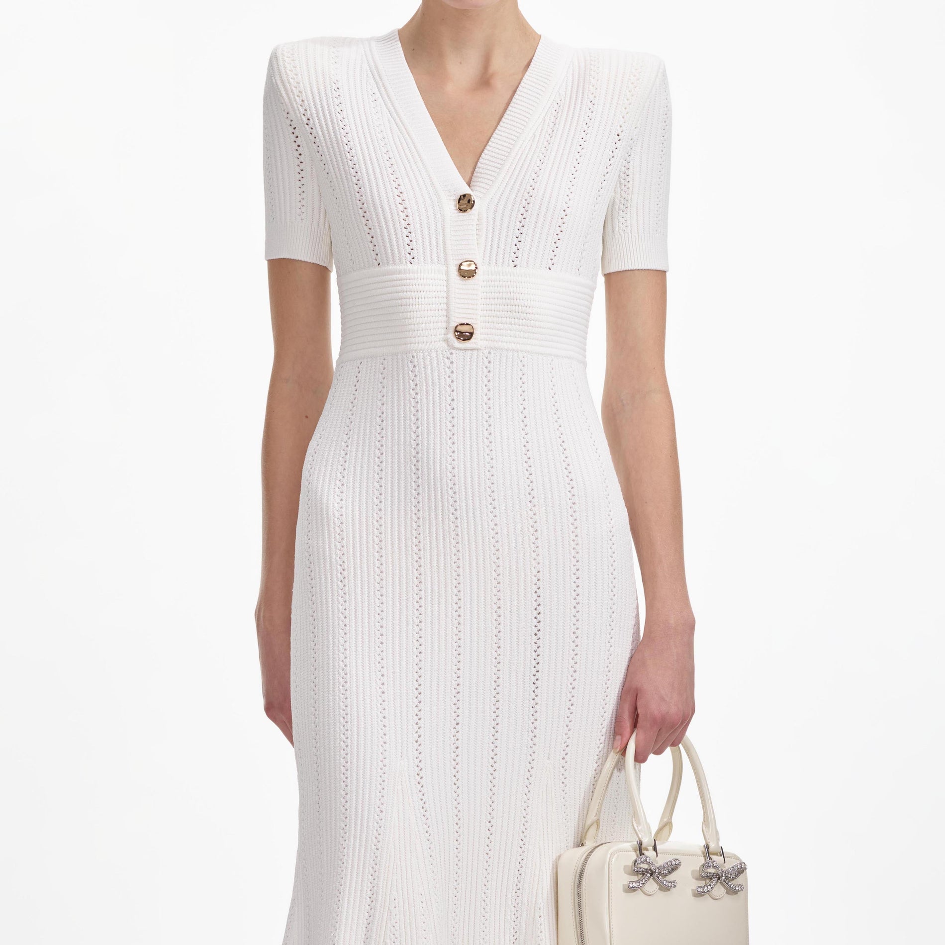 A close up of a woman wearing the Cream Pointelle Knit Midi Dress