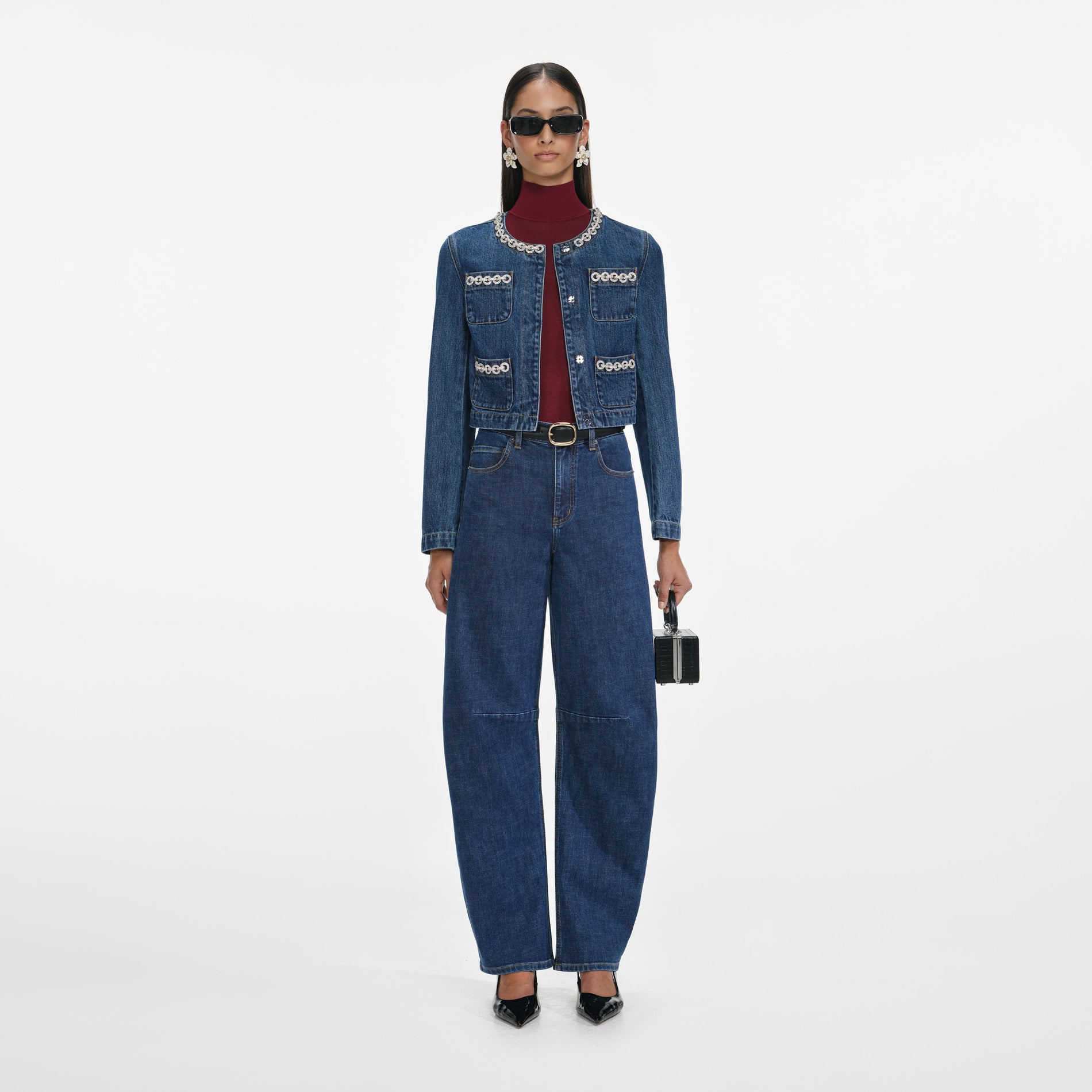 Front view of a woman wearing the Crystal Trim Denim Jacket