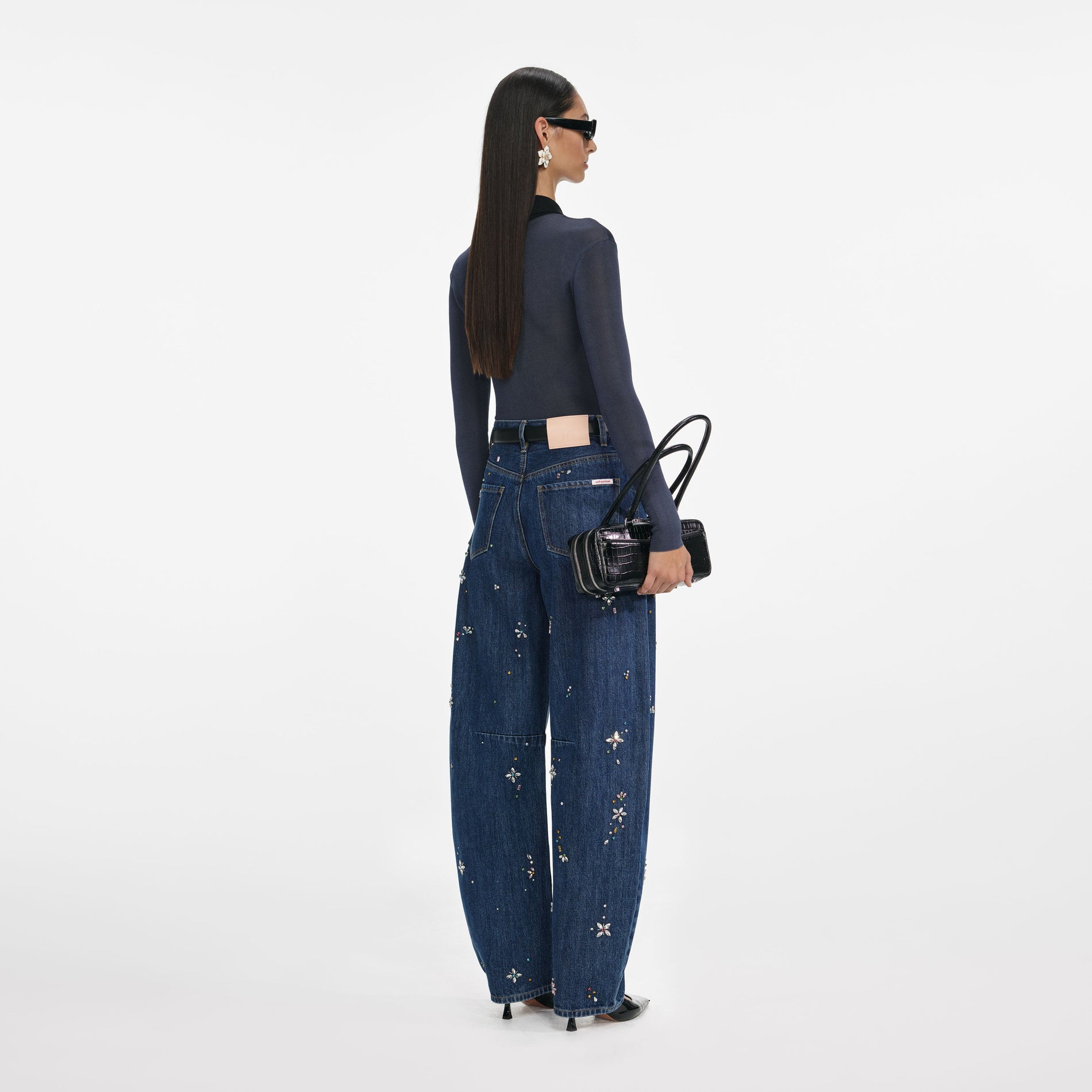 Back view of a woman wearing the Blue Embellished Barrel Leg Jeans