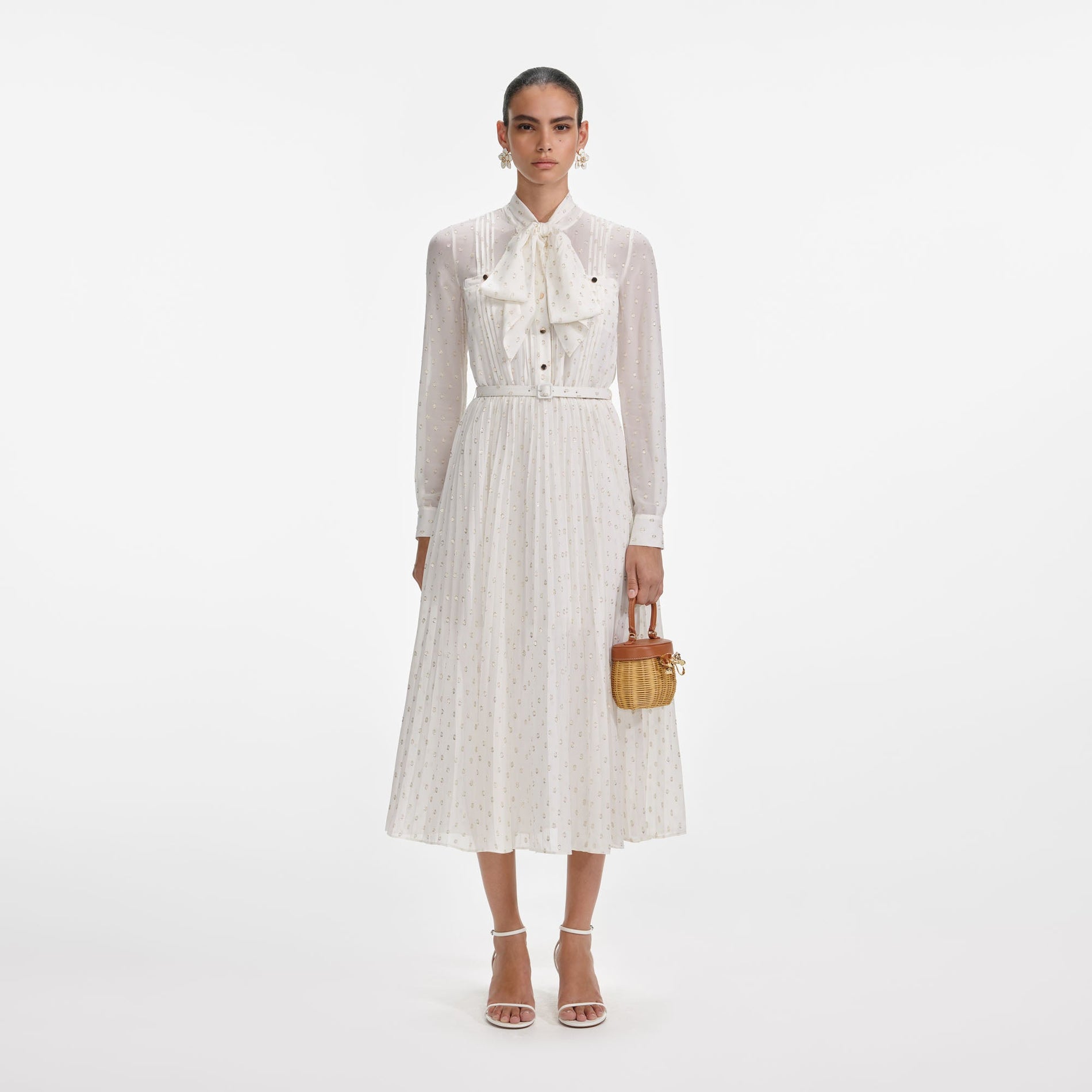 Front view of a woman wearing the Cream And Gold Pussy Bow Midi Dress