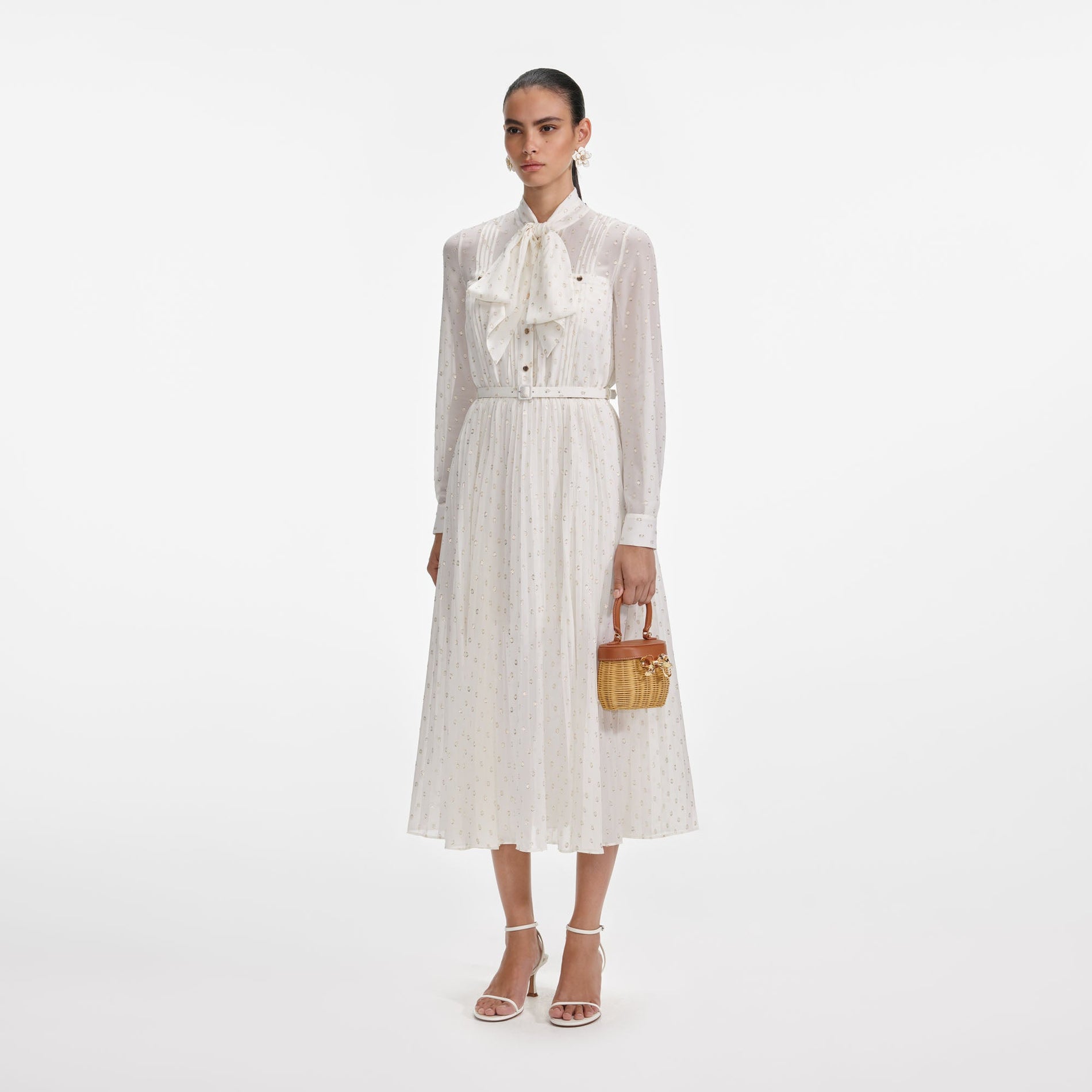 Side view of a woman wearing the Cream And Gold Pussy Bow Midi Dress