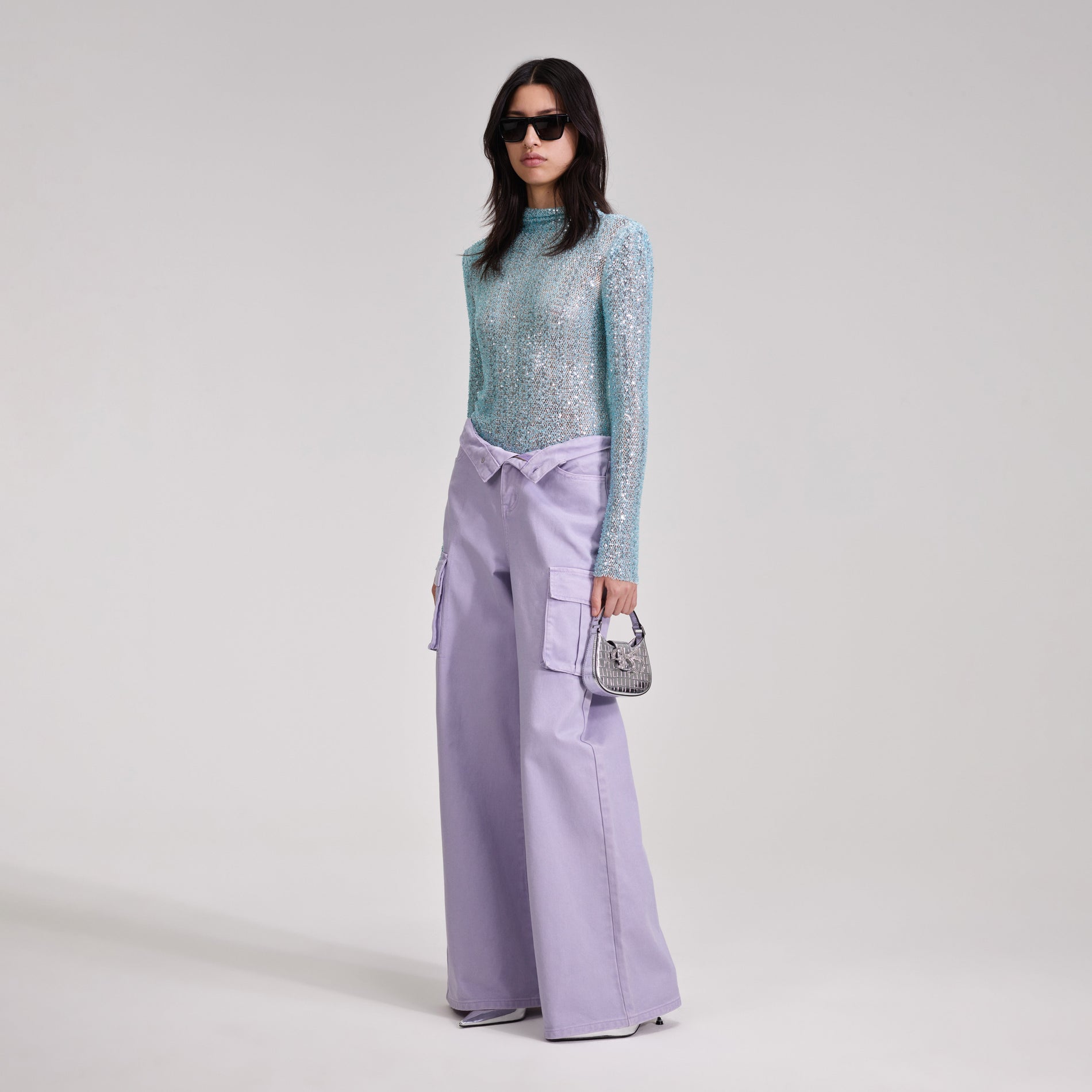 A woman wearing the Blue Beaded Top