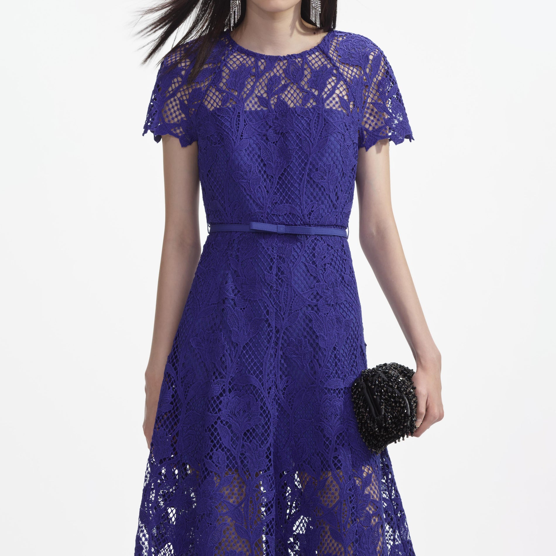 A close up of a woman wearing the Cobalt Lace Midi Dress