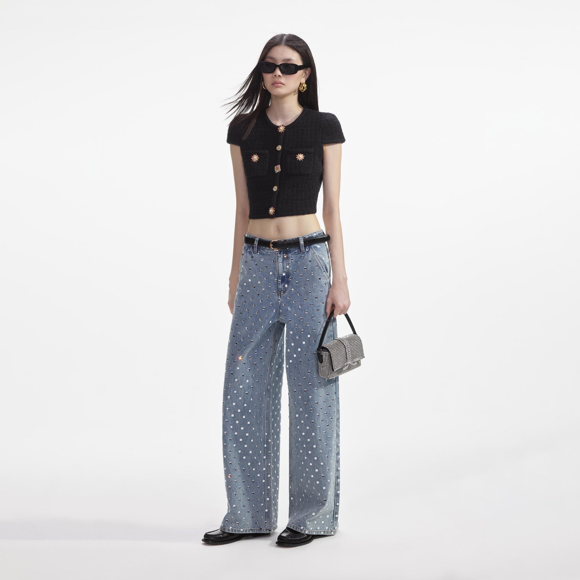 Side view of a woman wearing the Black Jewel Button Knit Top