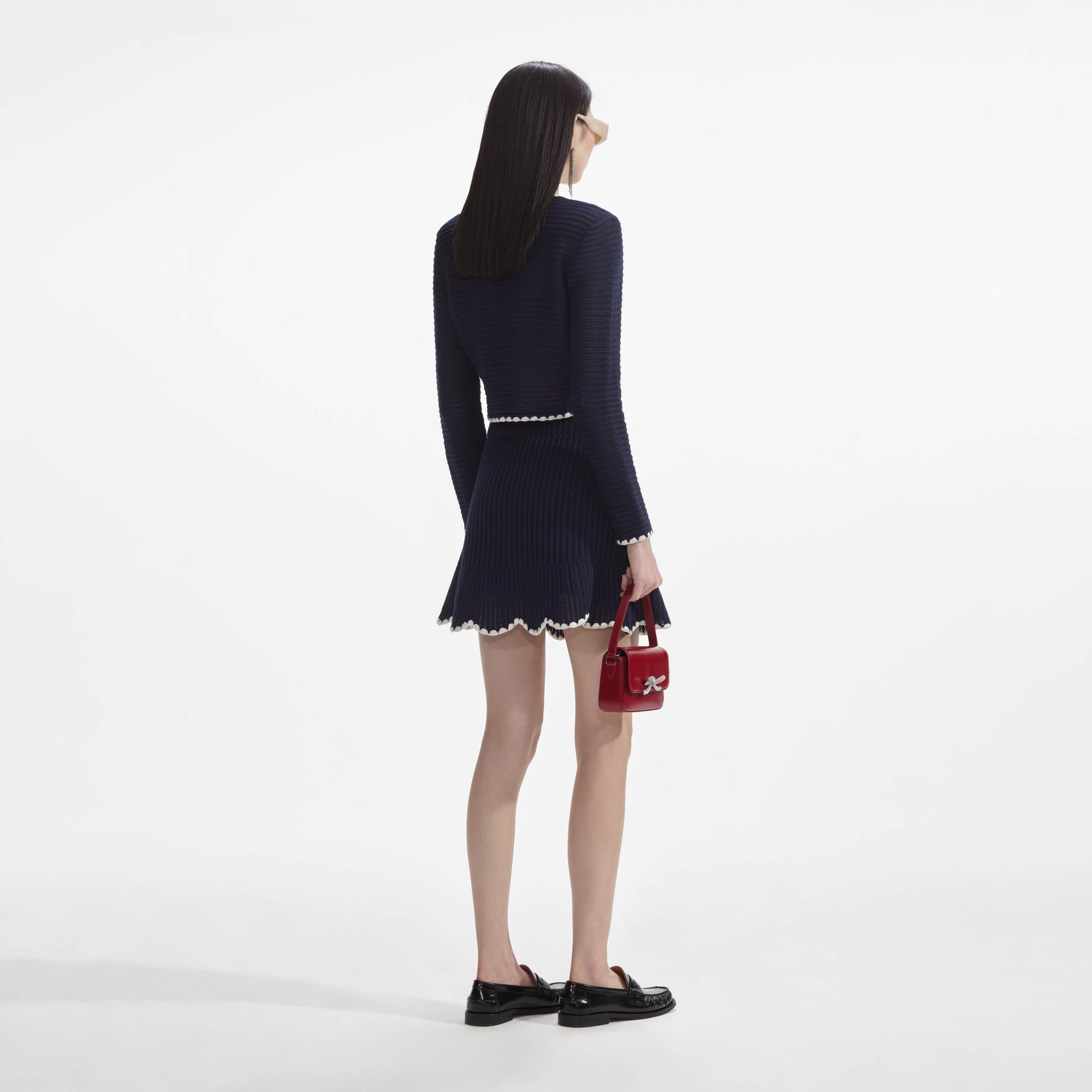 Back view of a woman wearing the Navy Crochet Contrast Trim Mini Skirt