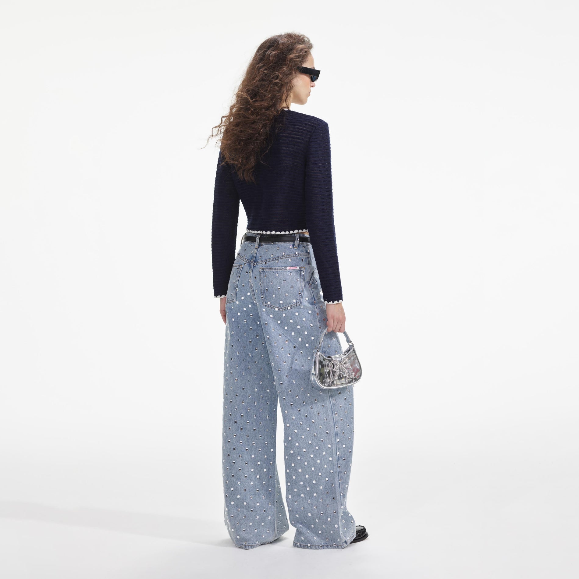 Back view of a woman wearing the Navy Crochet Contrast Trim Cardigan