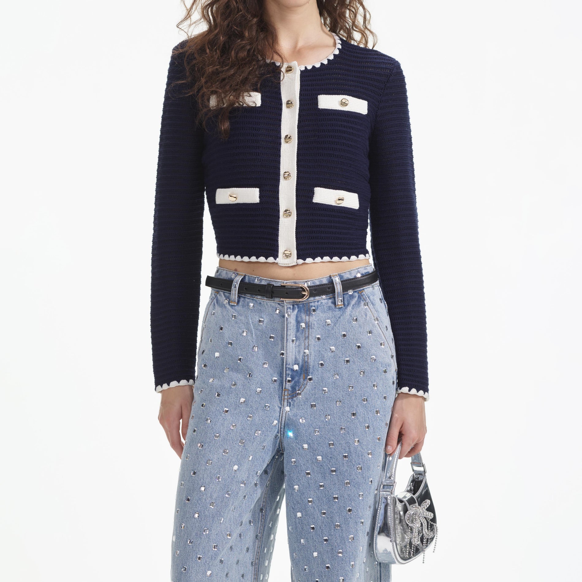 A close up of a woman wearing the Navy Crochet Contrast Trim Cardigan