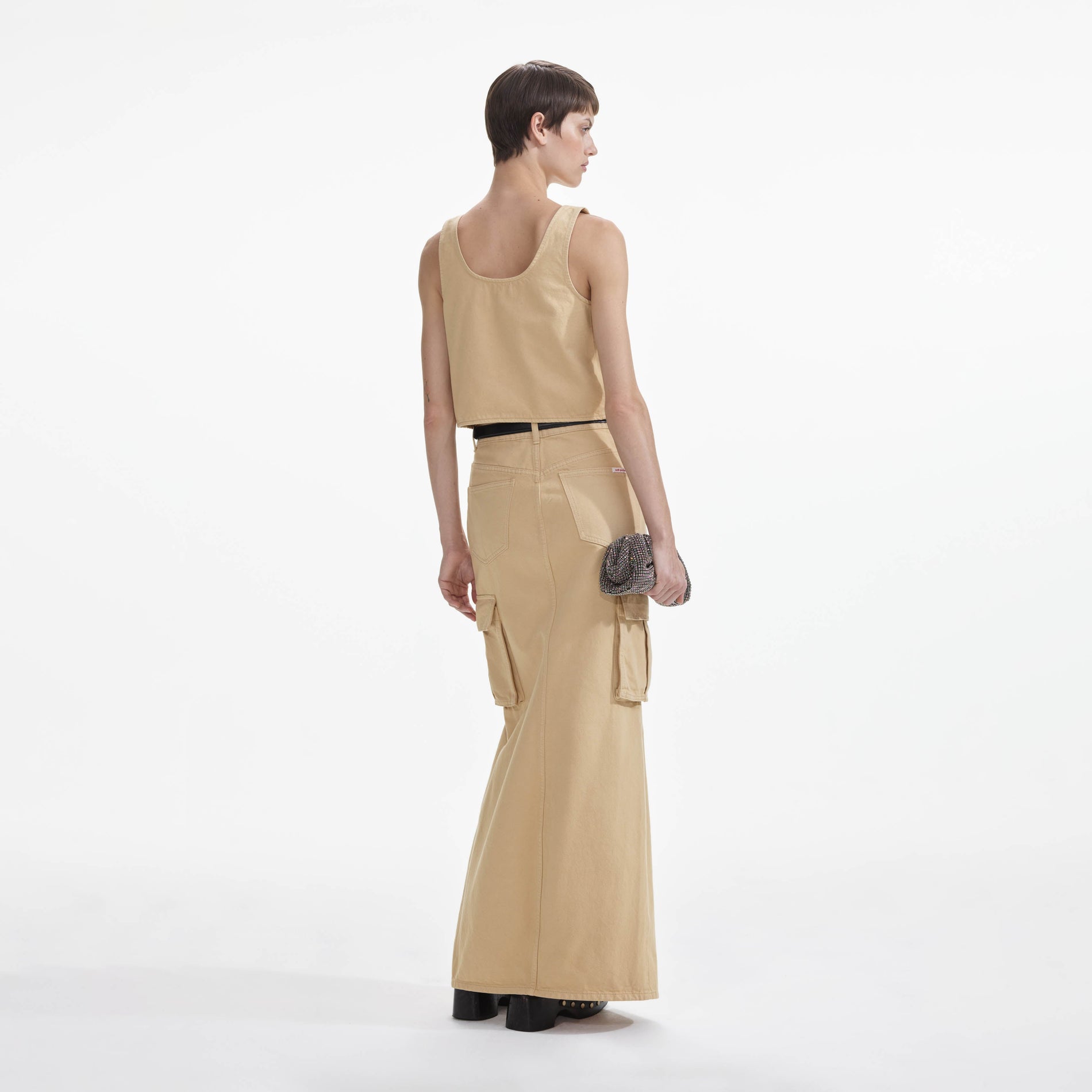 Back view of a woman wearing the Embellished Denim Cargo Maxi Skirt