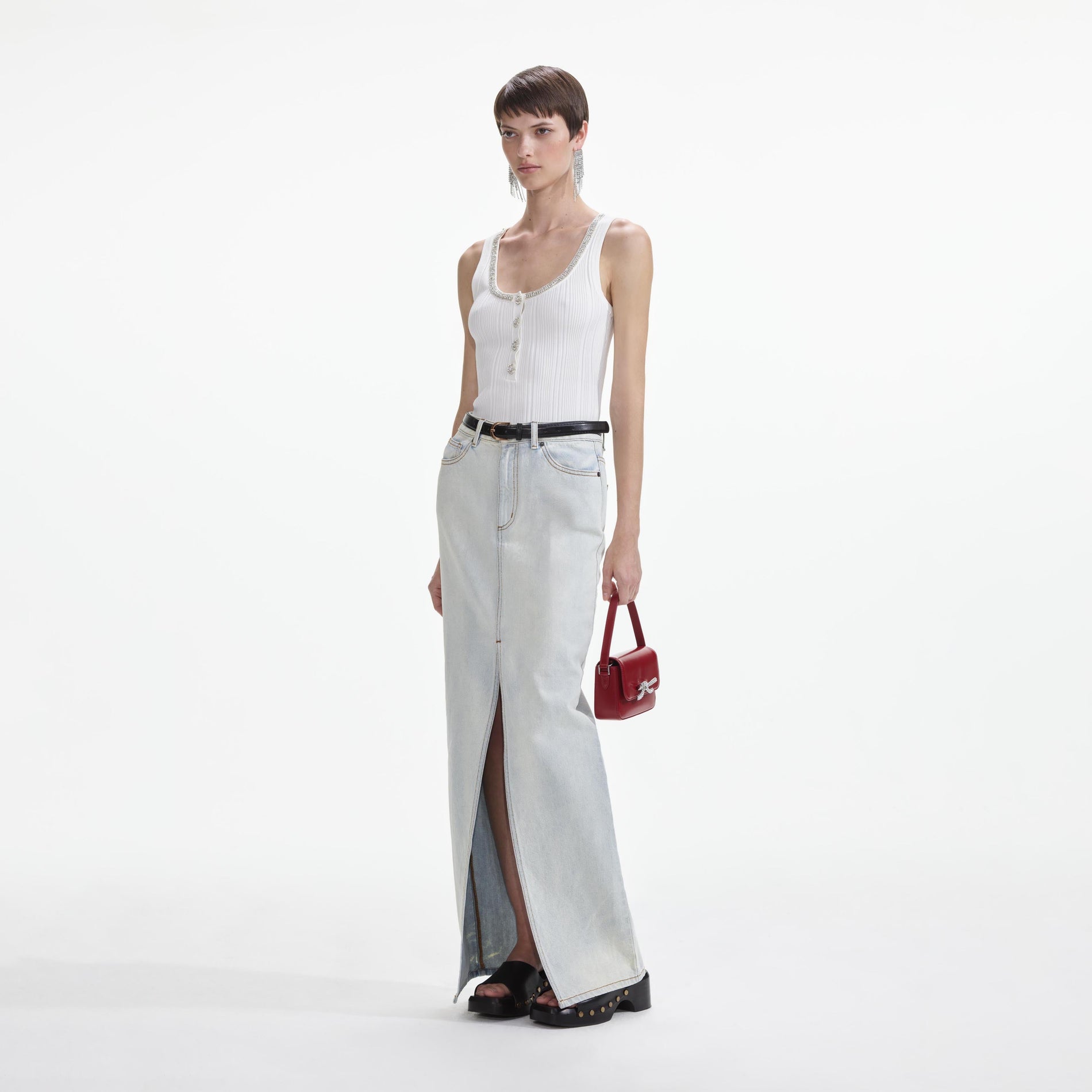 Side view of a woman wearing the Bleach Wash Denim Maxi Skirt