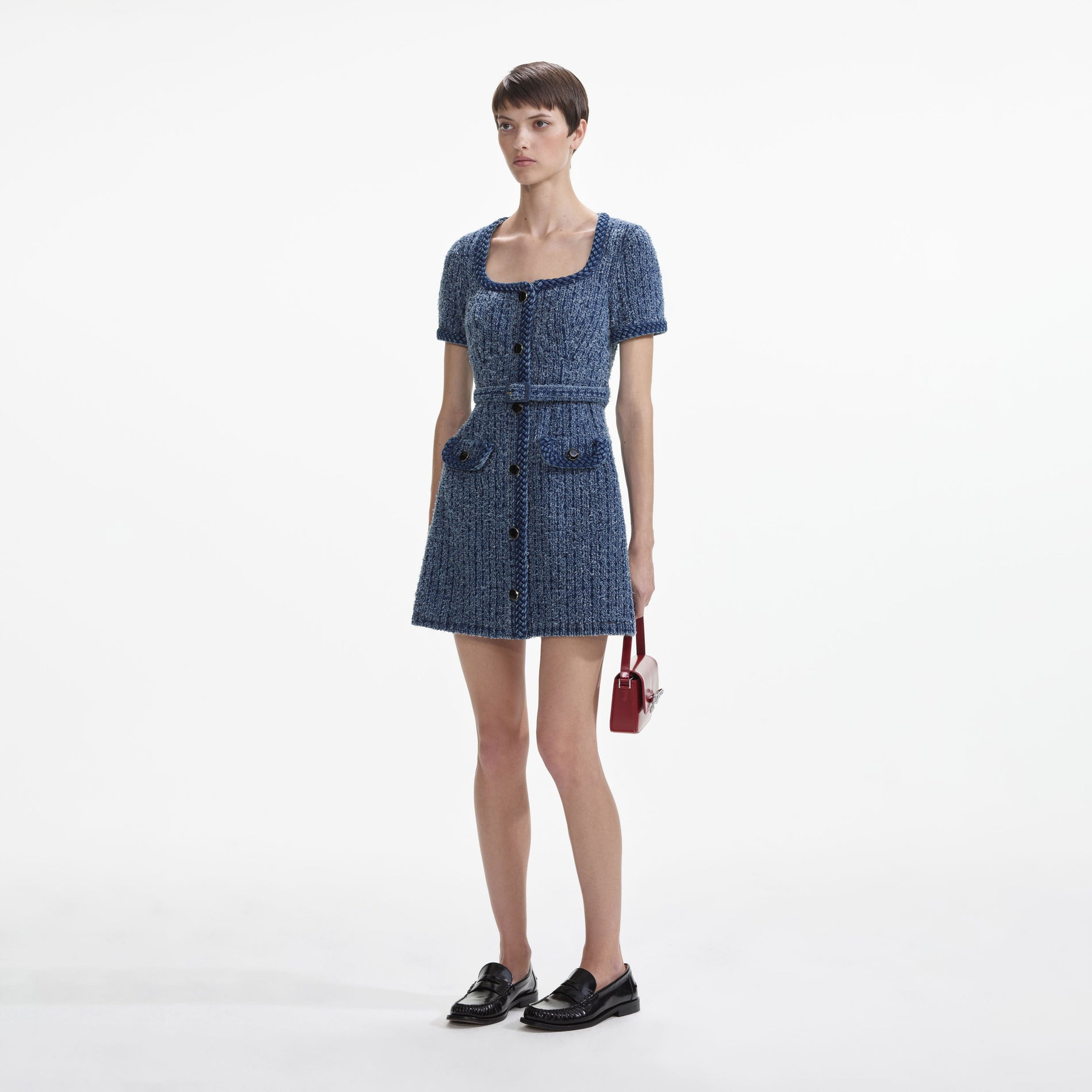 Side view of a woman wearing the Textured Denim Short Sleeve Mini Dress