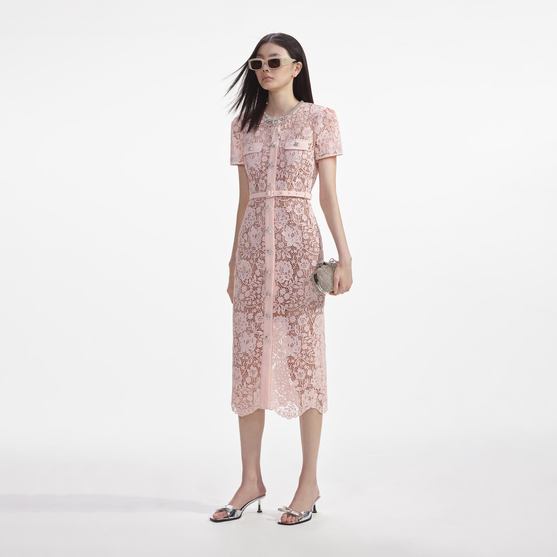 Side view of a woman wearing the Pink Lace Diamante Bow Midi Dress