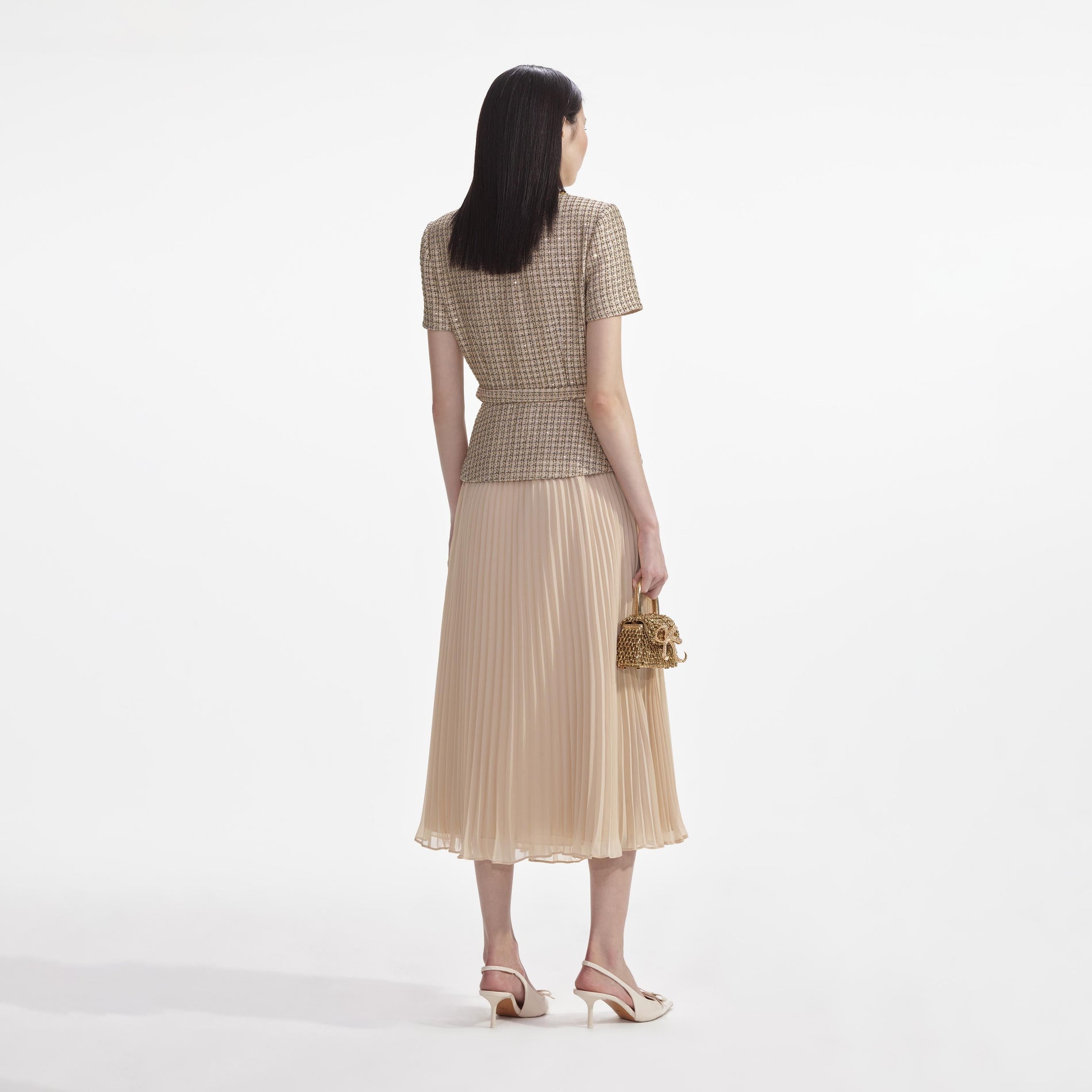 Back view of a woman wearing the Gold Boucle Midi Dress