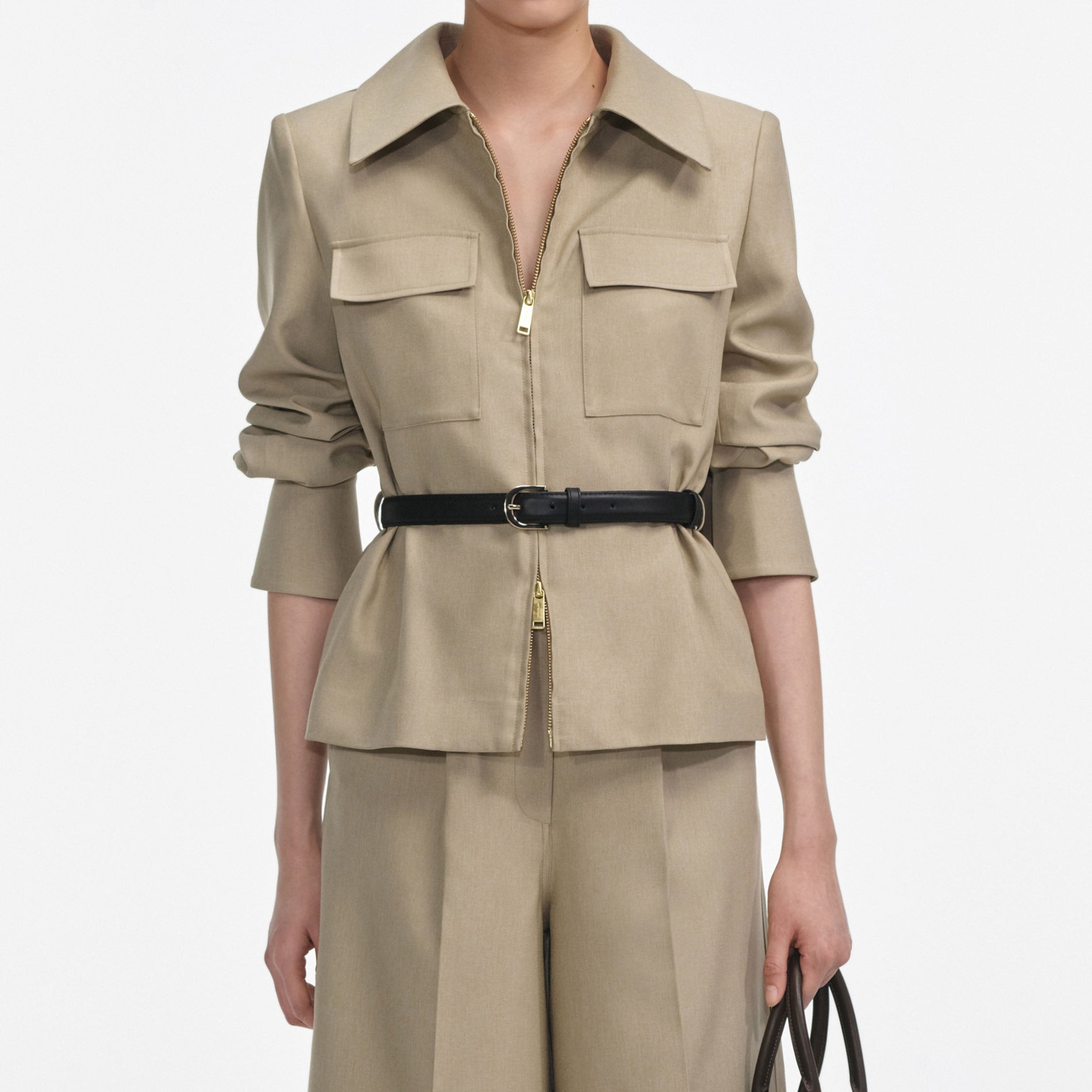 A close up of a woman wearing the Beige Twill Playsuit