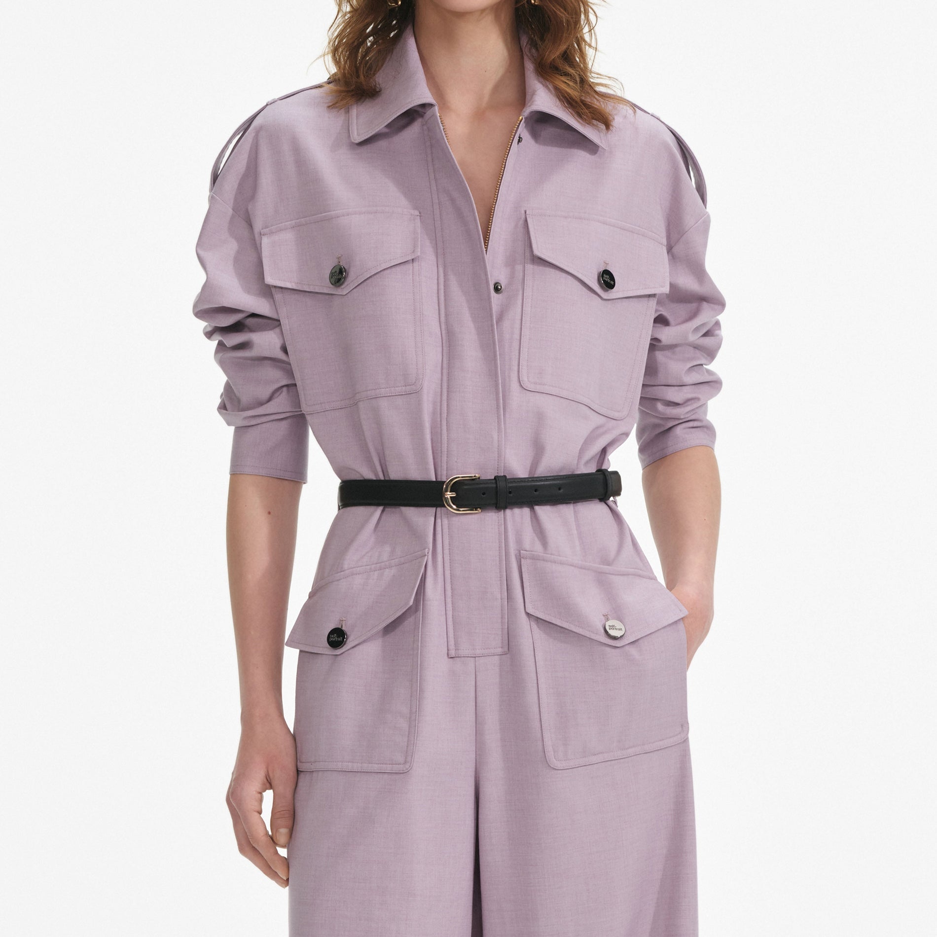 A close up of a woman wearing the Lilac Twill Jumpsuit
