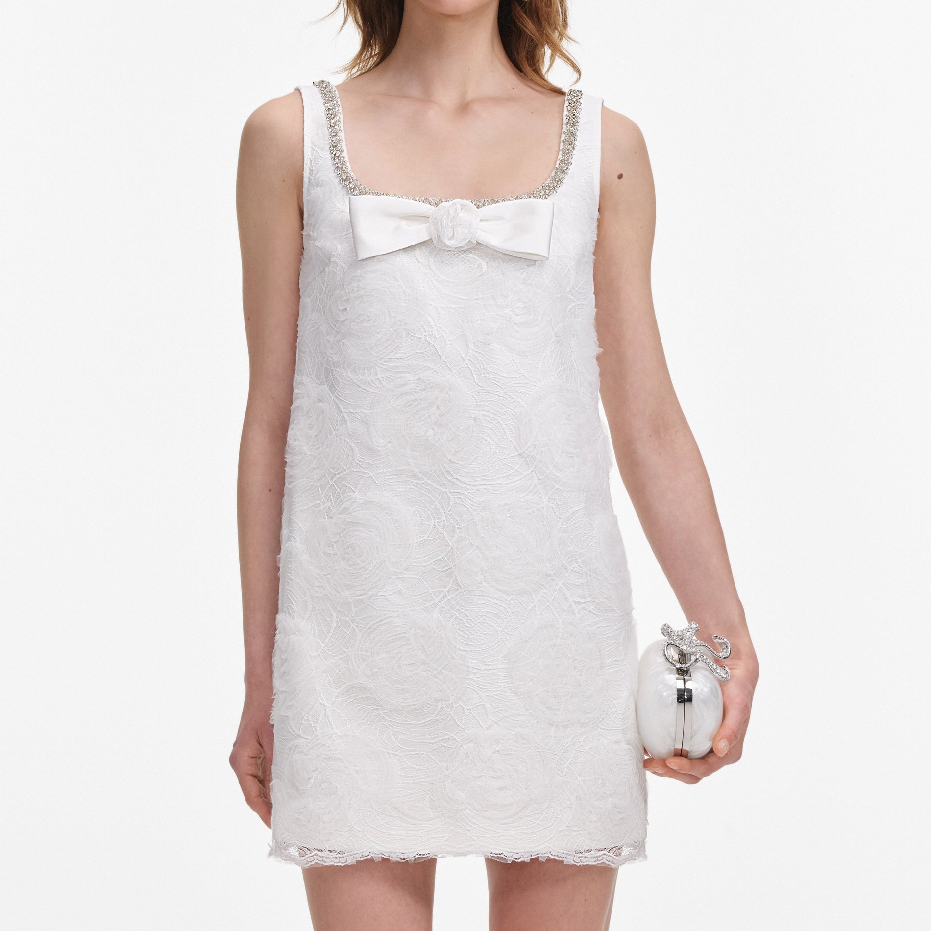 A close up of a woman wearing the White Tulle Lace Mini Dress