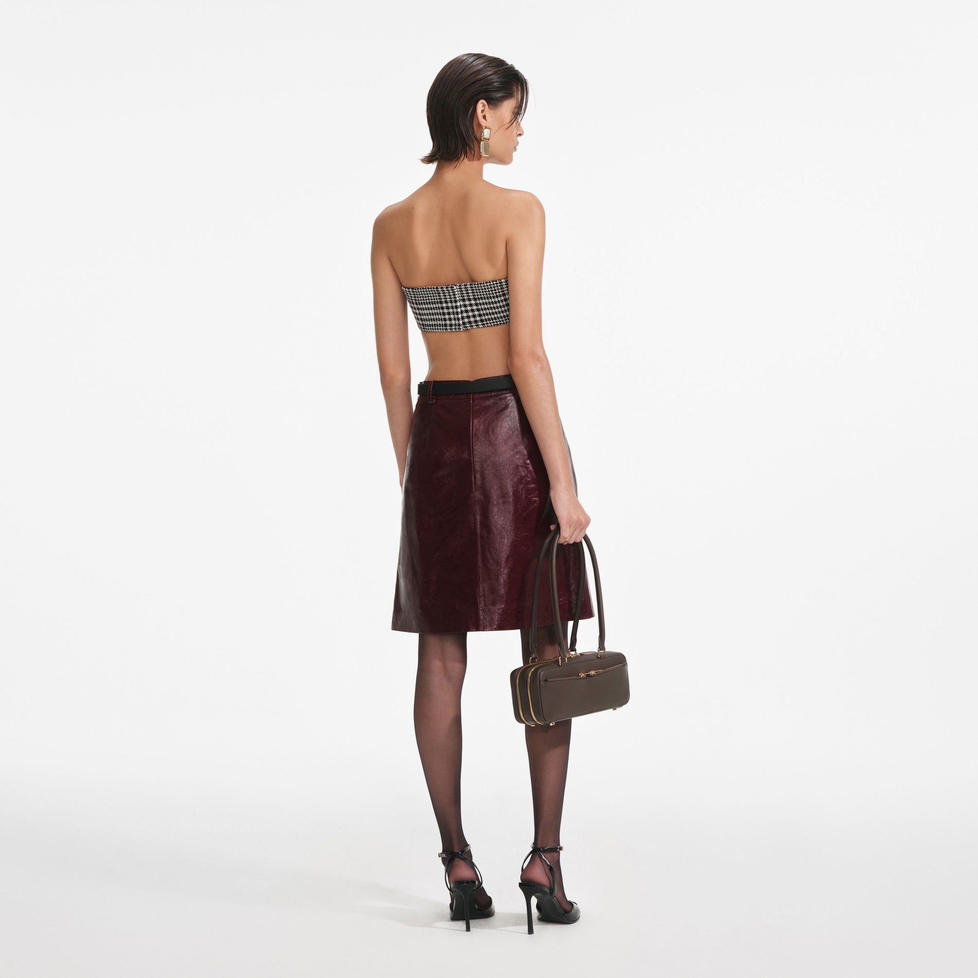 Back view of a woman wearing the Burgundy Leather  Mini Skirt
