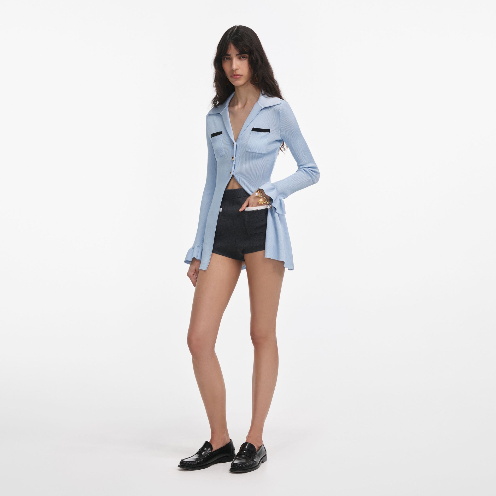 Side view of a woman wearing the Blue Ribbed Viscose Knit Longline Top