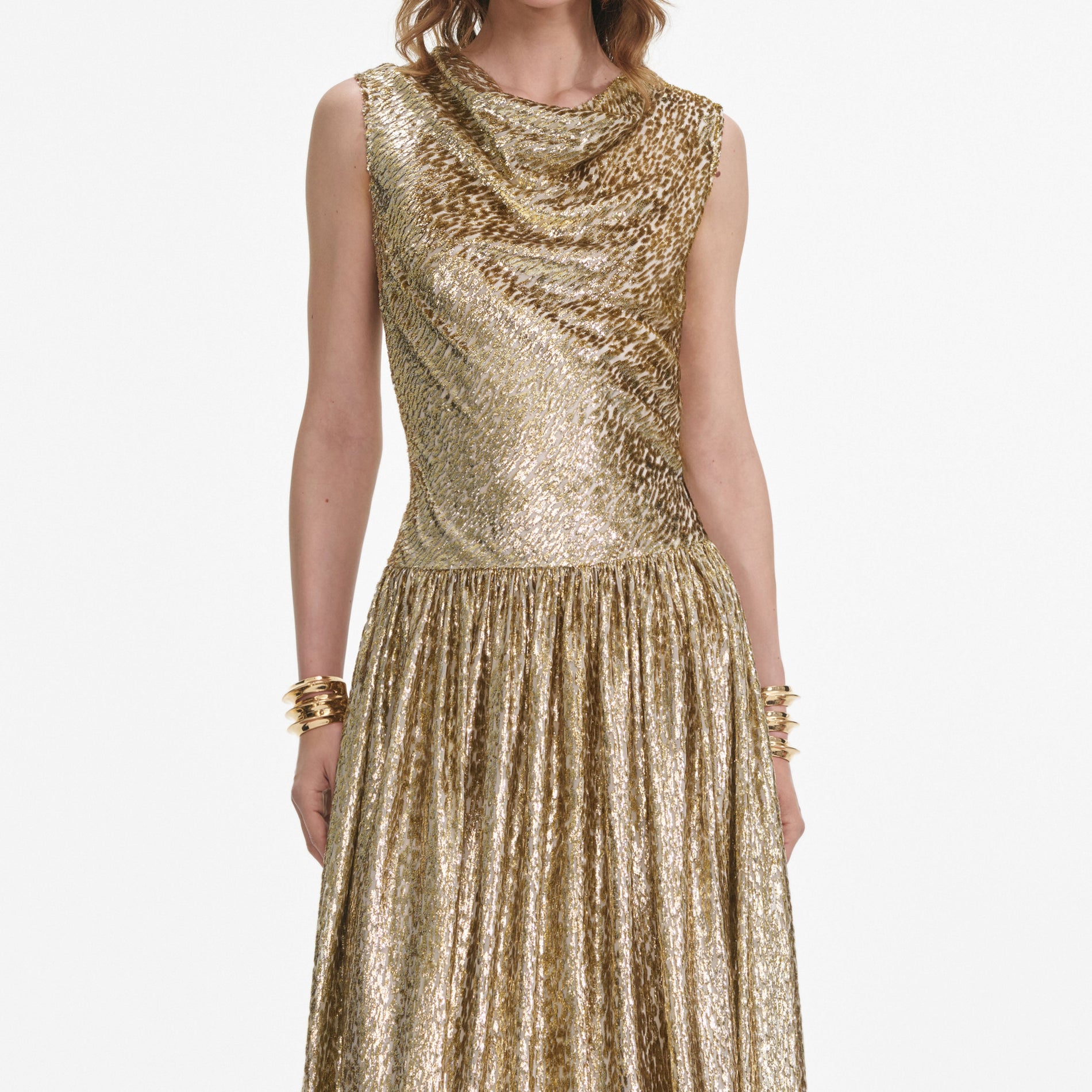 A close up of a woman wearing the Gold Sleeveless Fil Coupe Maxi Dress