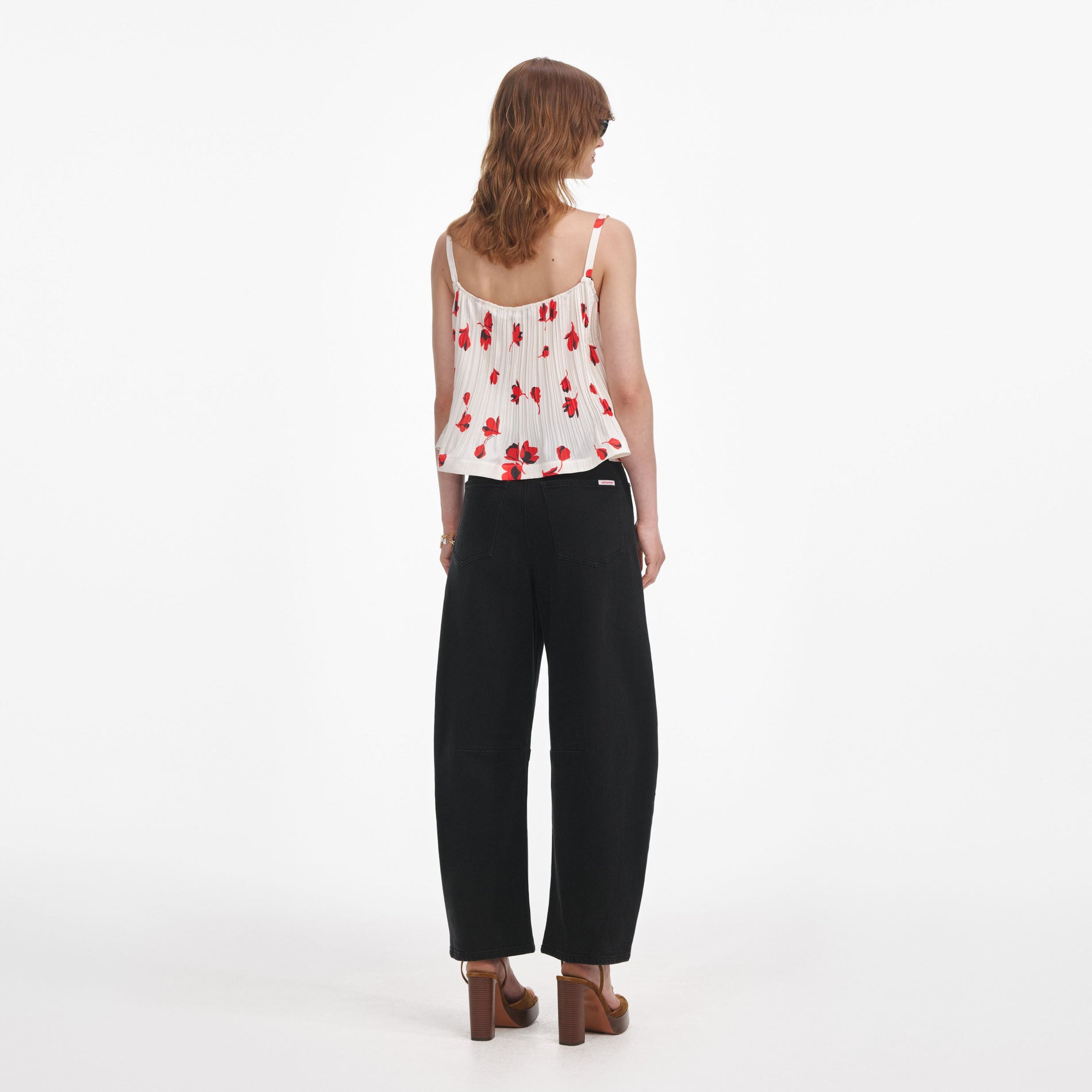 Back view of a woman wearing the White Floral Plisse  Top
