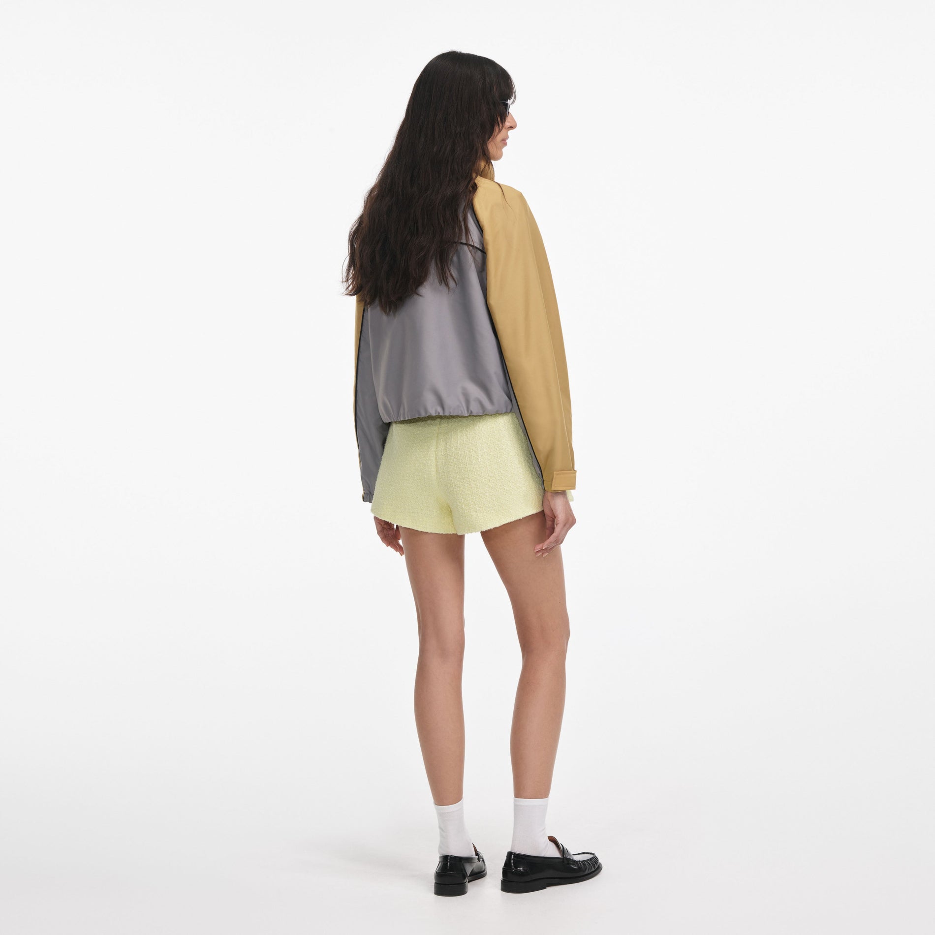Back view of a woman wearing the Grey Nylon Cropped Windbreaker