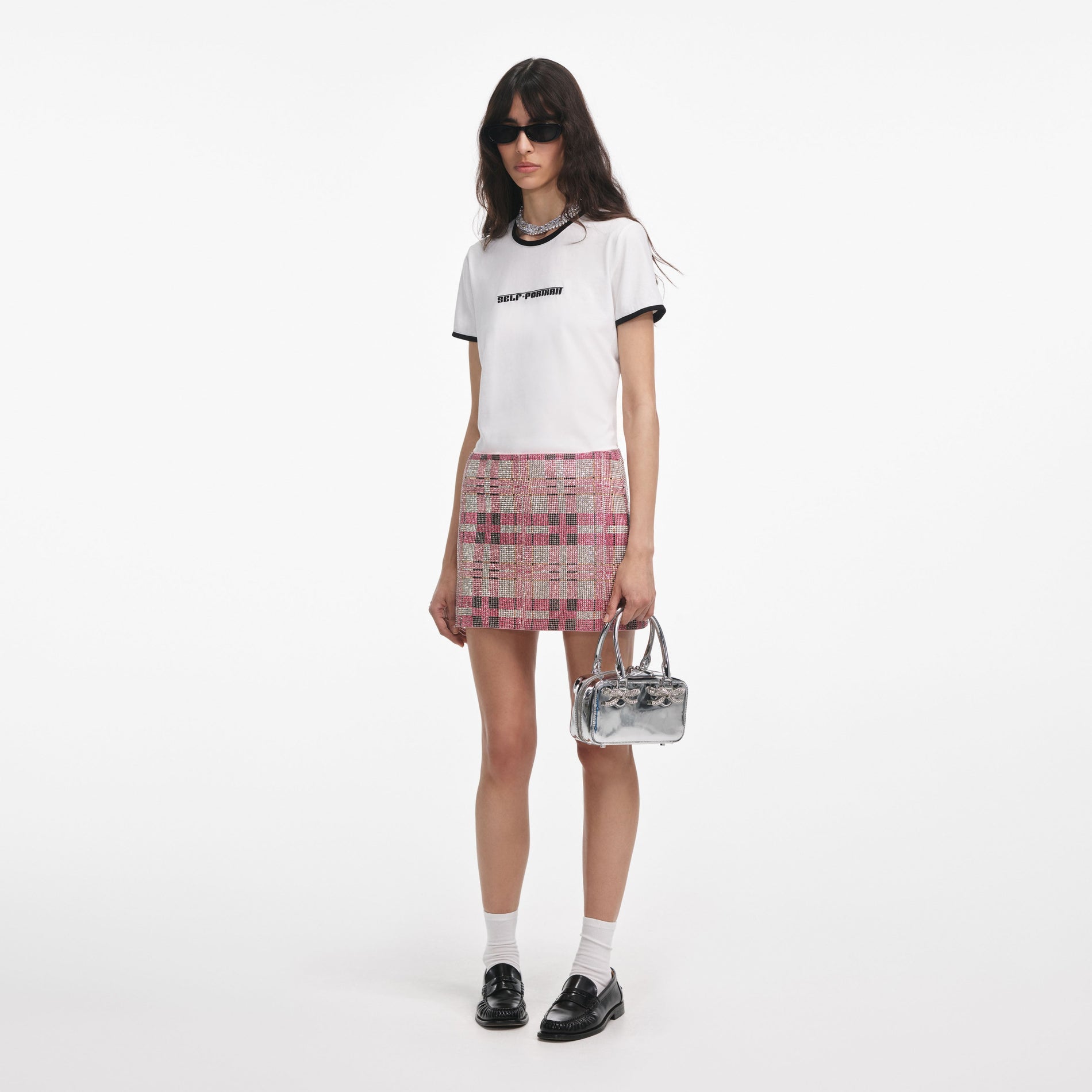 Side view of a woman wearing the White T-Shirt With Embroidered Logo