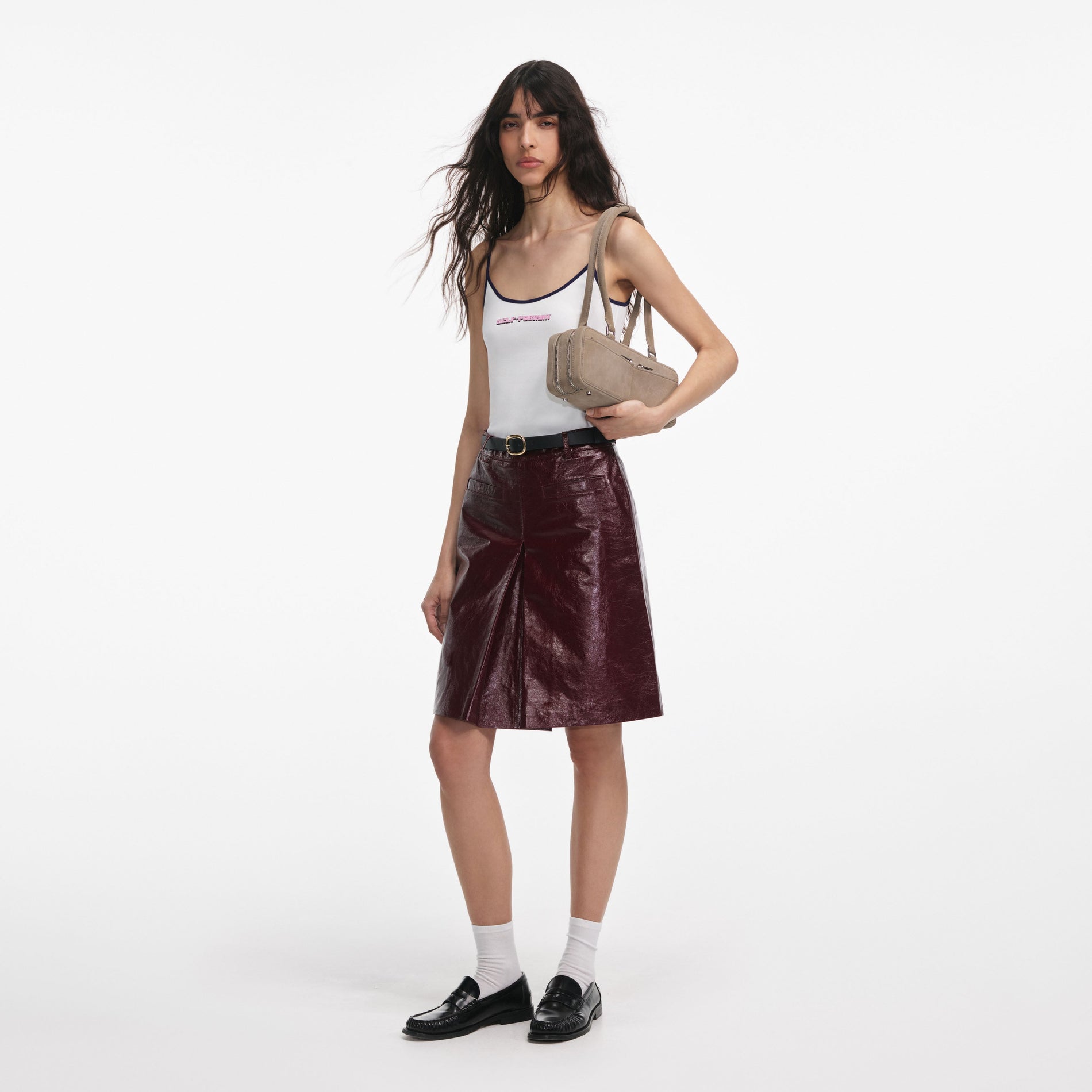 Side view of a woman wearing the White Vest With Pink Logo