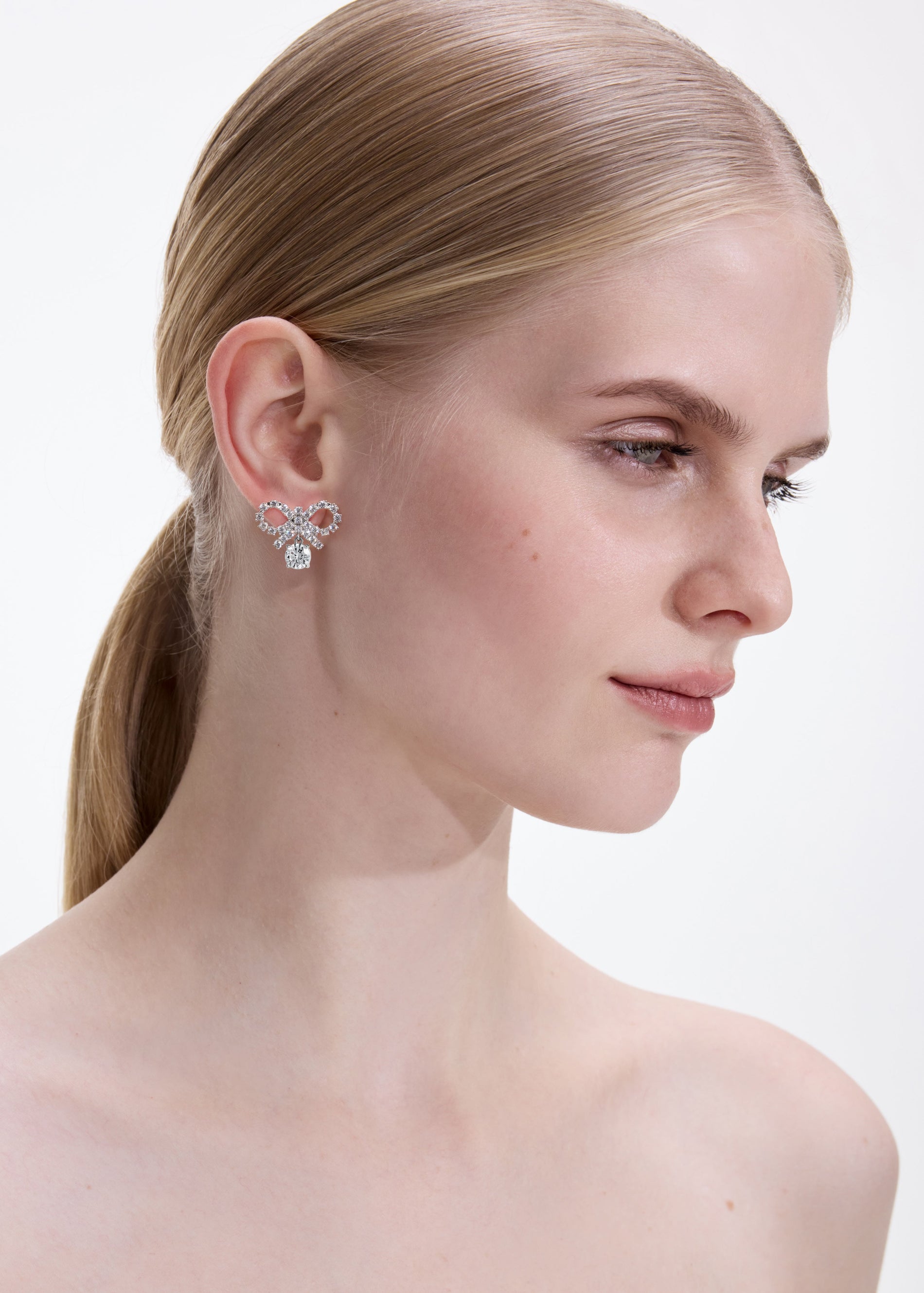 A photo of the Micro Bow Crystal Earrings