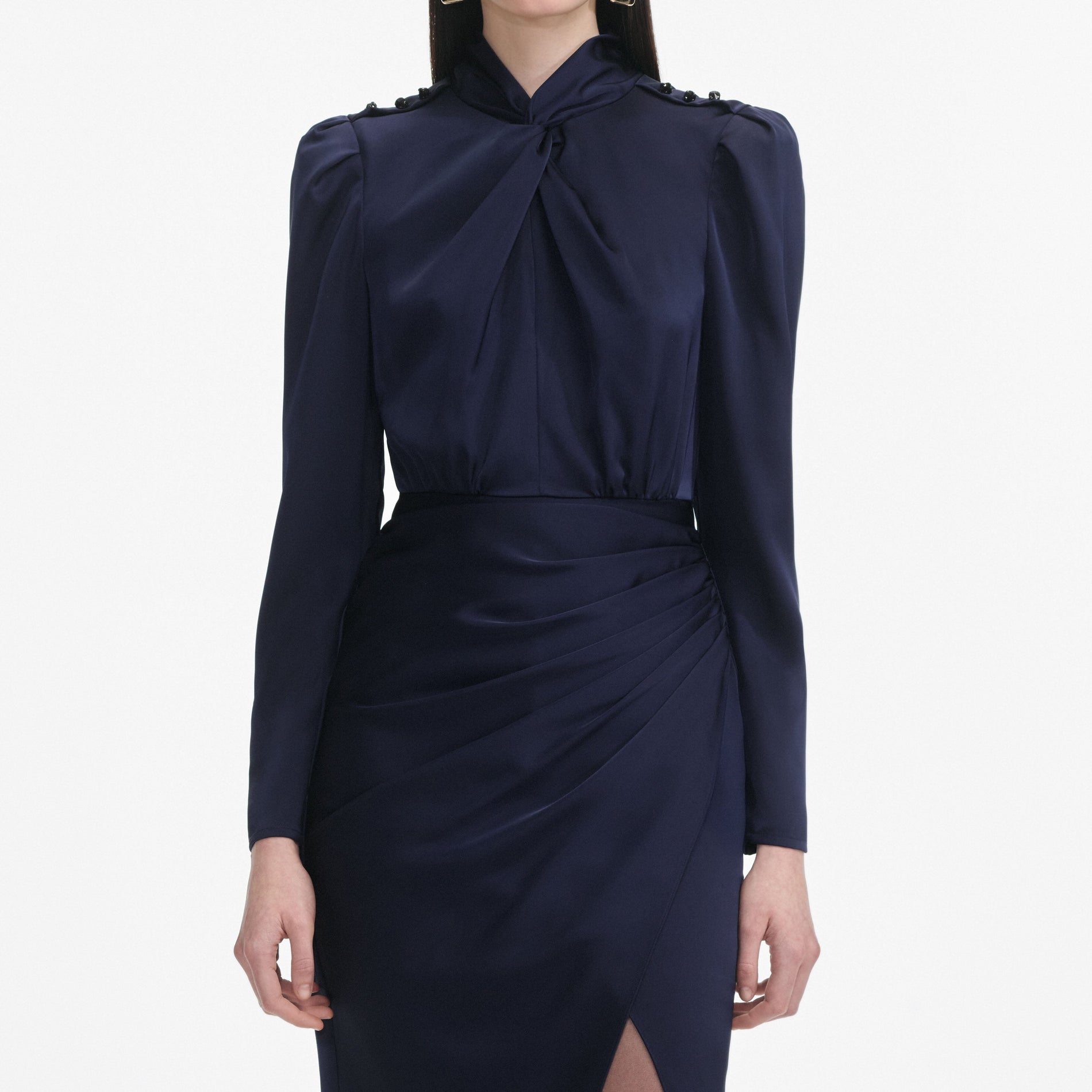 A close up of a woman wearing the Navy Satin Midi Dress
