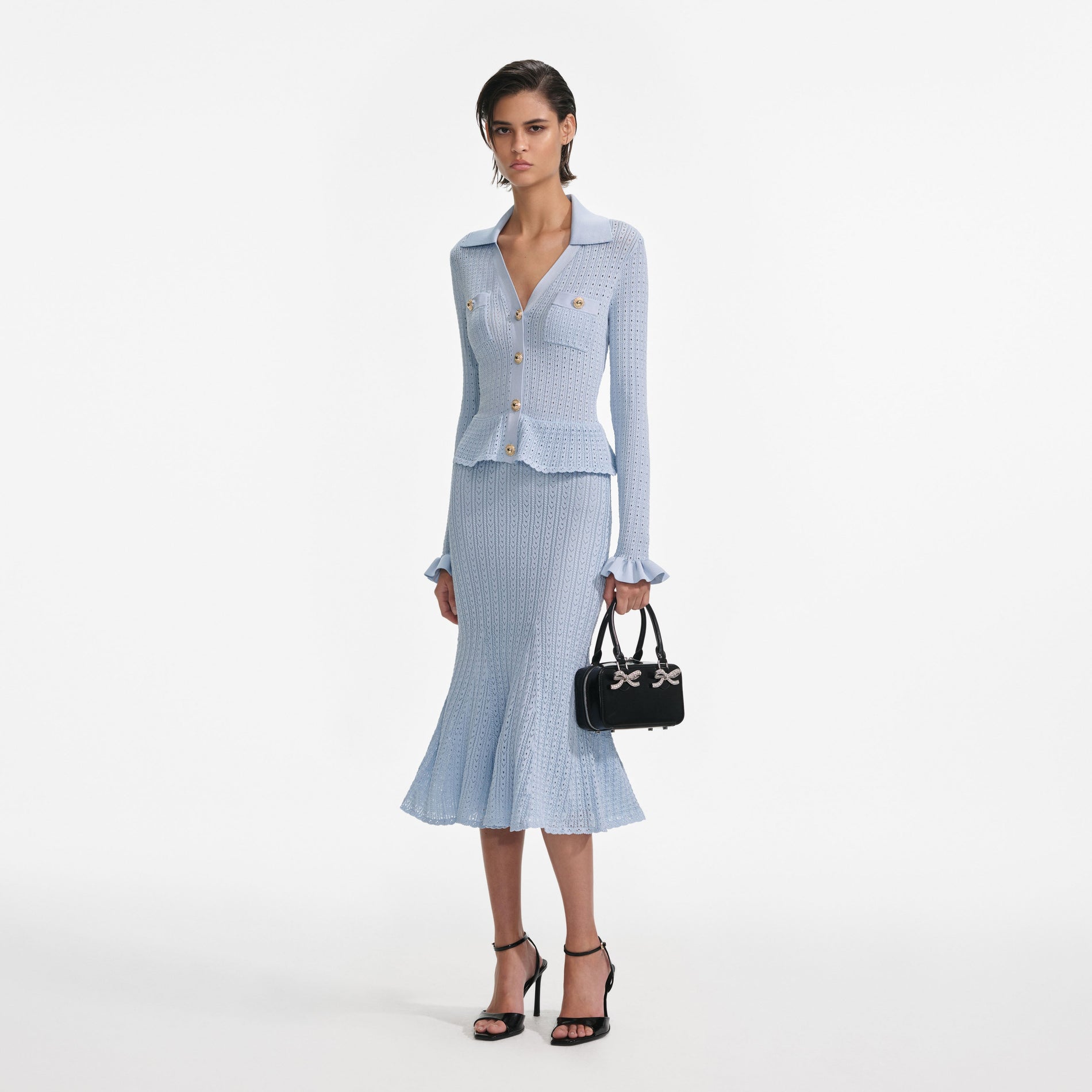 Side view of a woman wearing the Blue Pointelle Knit Midi Dress