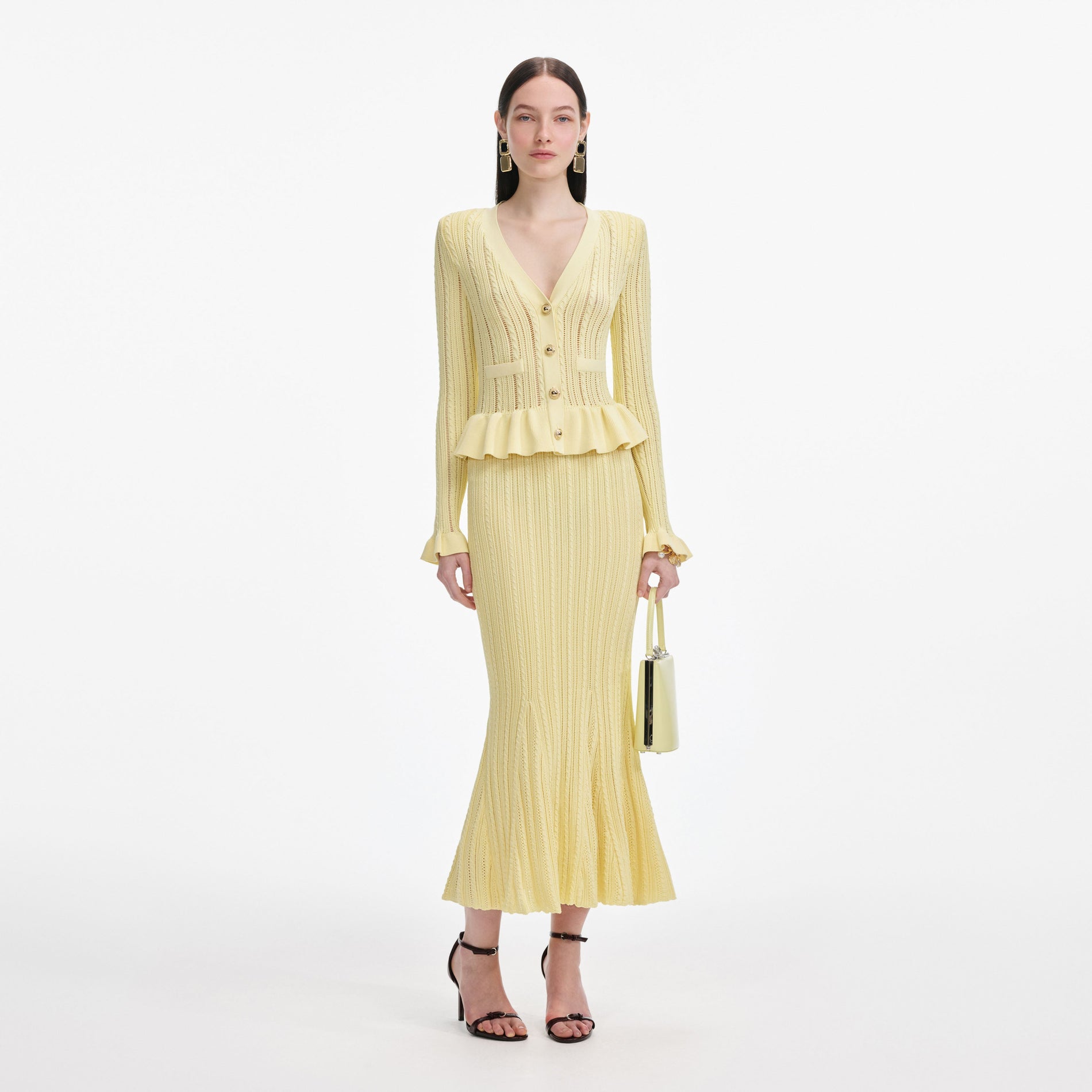 Front view of a woman wearing the Yellow Knit Peplum Midi Dress