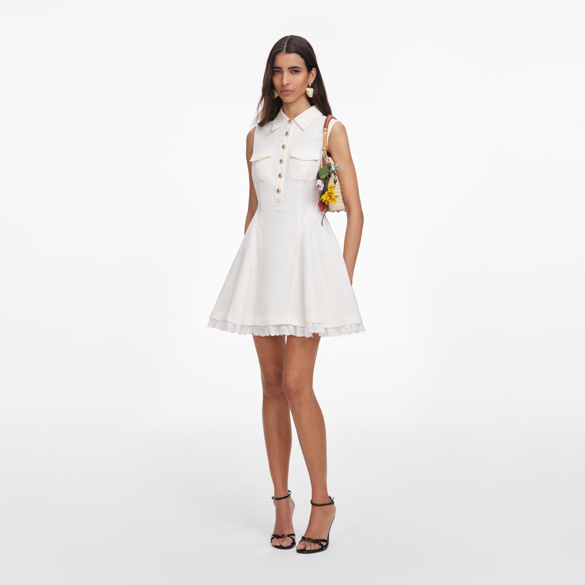 Side view of a woman wearing the Cream Linen Blend Sleeveless Mini Dress