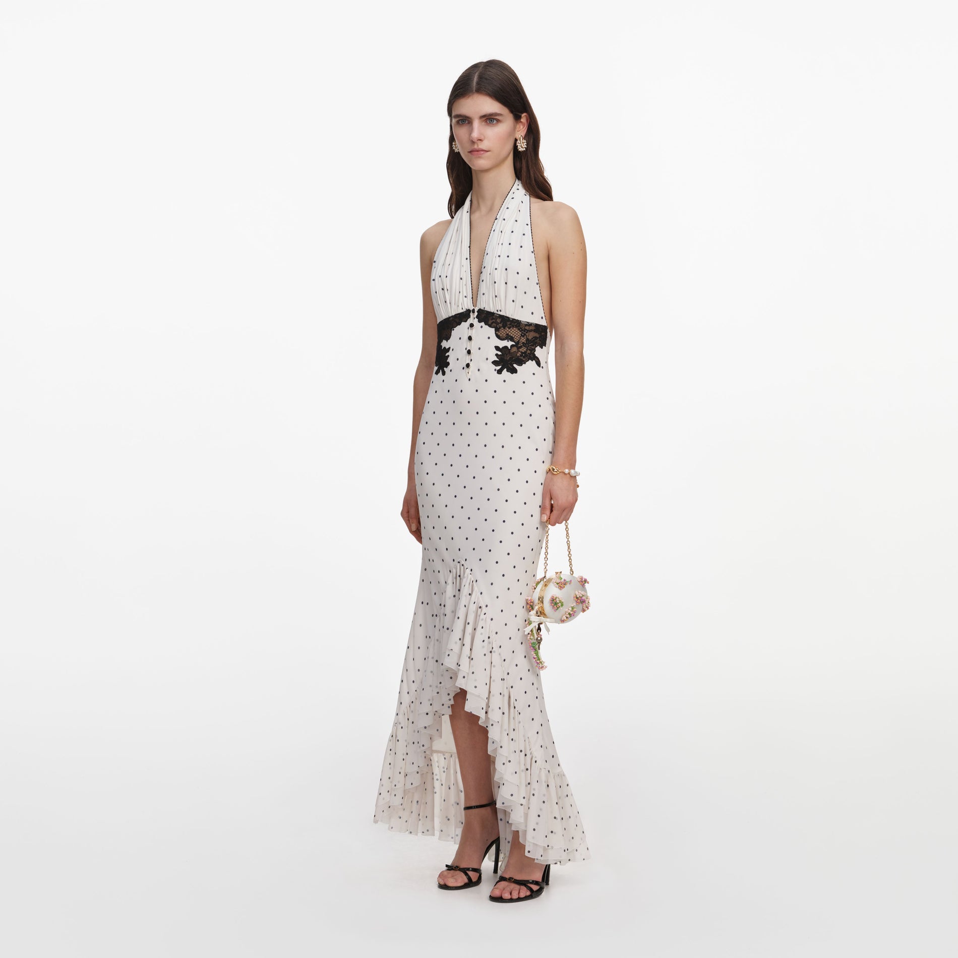 Side view of a woman wearing the Polka Dot Halter Neck Midi Dress