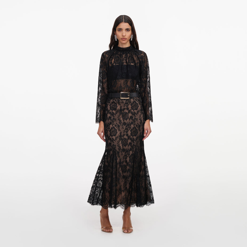 Front view of a woman wearing the Black Lace Midi Skirt