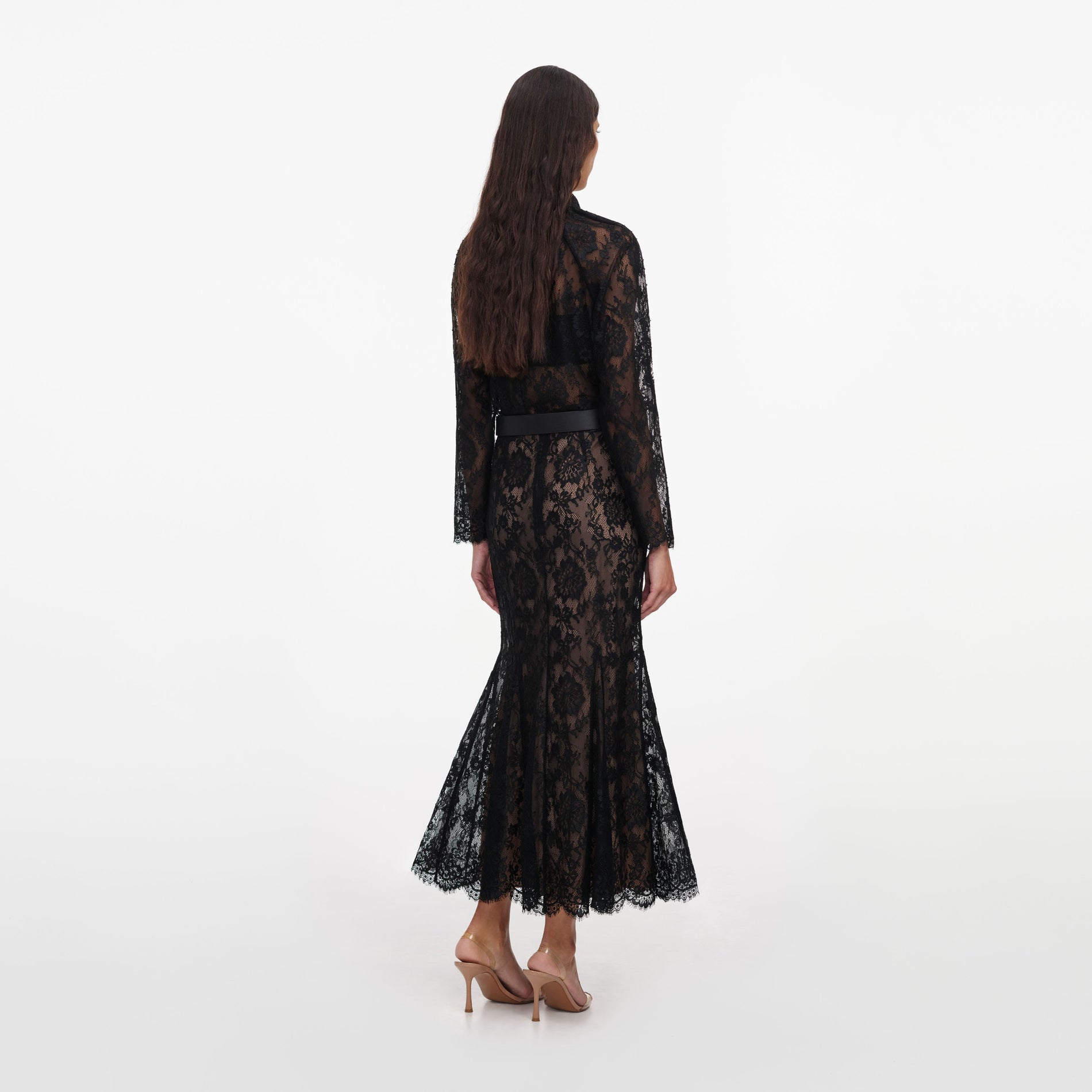 Back view of a woman wearing the Black Lace Midi Skirt