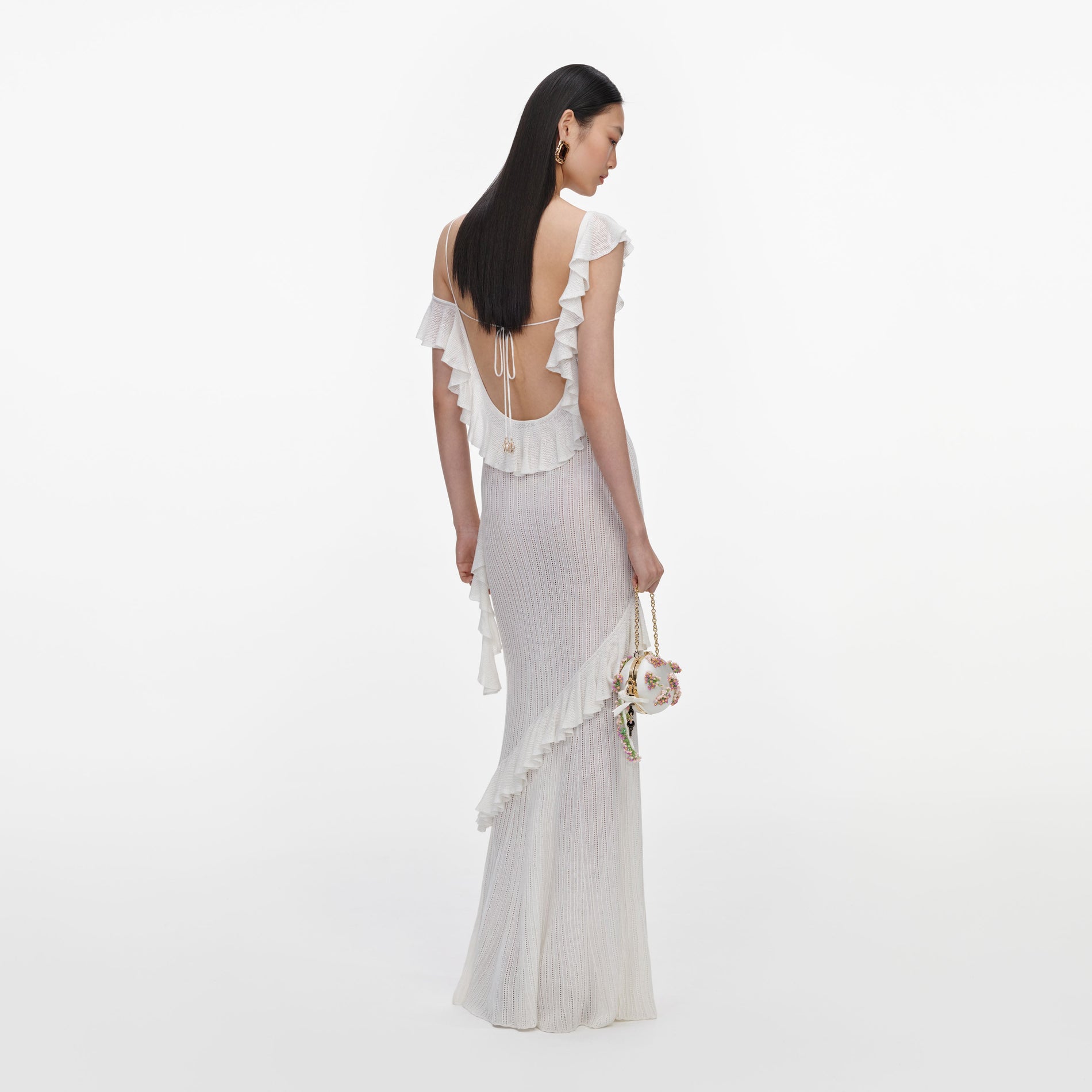 Back view of a woman wearing the White Ruffle Knit Maxi Dress