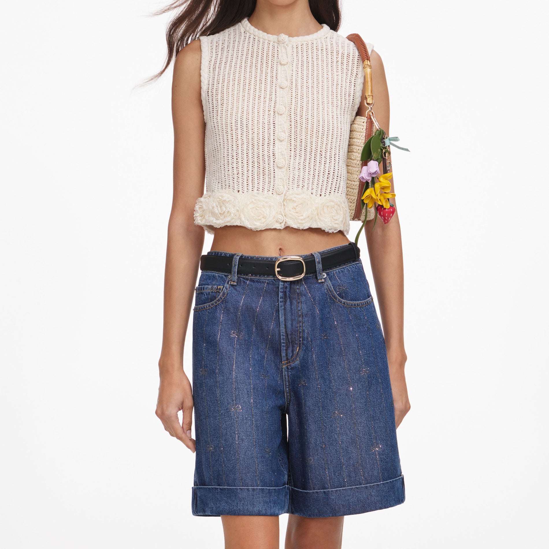 A close up of a woman wearing the Cream Crochet Flower Knit Top