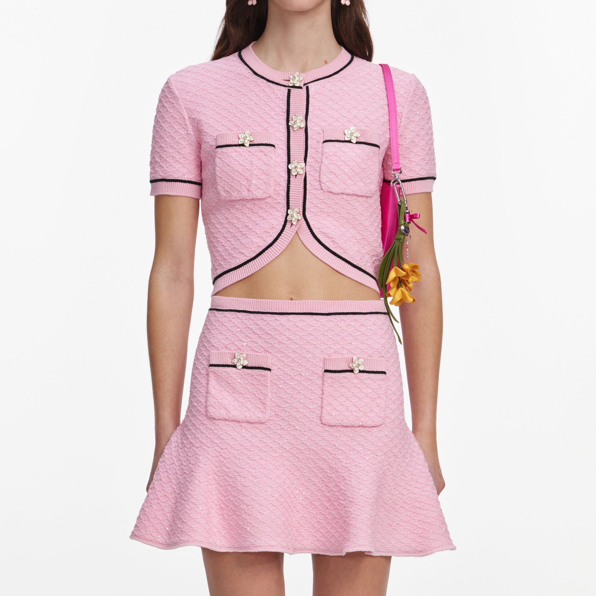 A close up of a woman wearing the Pink Flower Knit Mini Skirt